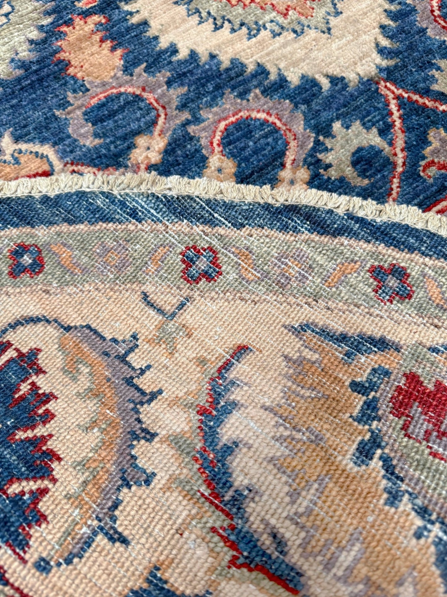 Round Oushak rug with blue field, beige border, muted gold, dusty red floral details, handmade wool 6x6 round area rug from Indigo Rugs Burlingame Bay Area.