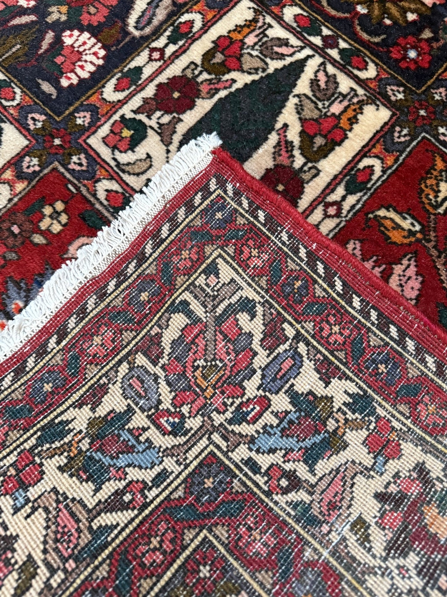 Vintage Persian Bakhtiari rug wit red field, navy garden panels, ivory details, and intricate floral motifs, handmade wool area rug 5x8 from Indigo Rugs Burlingame SF Bay Area