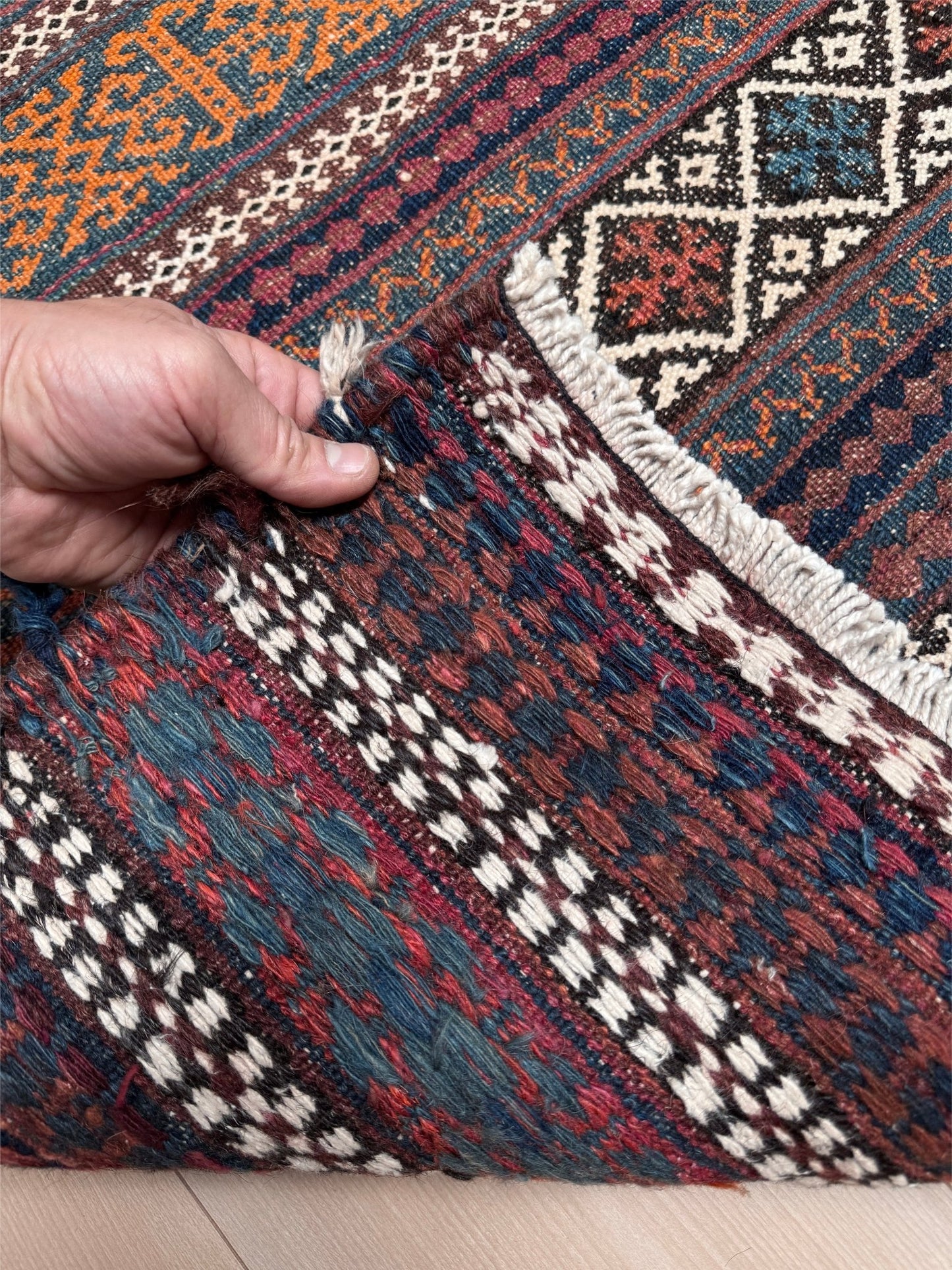 Vintage Persian tribal kilim rug with geometric horizontal bands, brick red, indigo blue, orange, decorative side tassels, handmade wool flatweave 5x6 from Indigo Rugs Burlingame Bay Area.