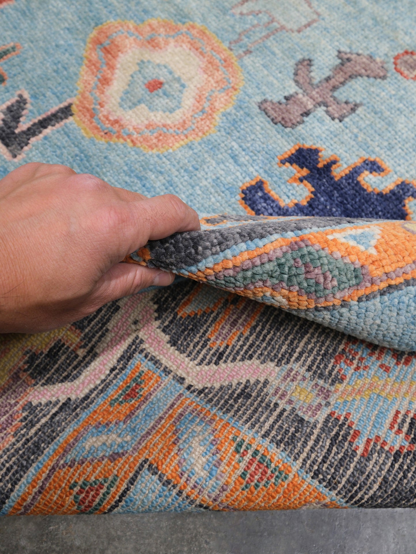 Pale turquoise Turkish Oushak rug with charcoal border, coral orange framing, and colorful abstract floral motifs, hand-knotted wool 8x10 area rug from Indigo Rugs Burlingame Bay Area.
