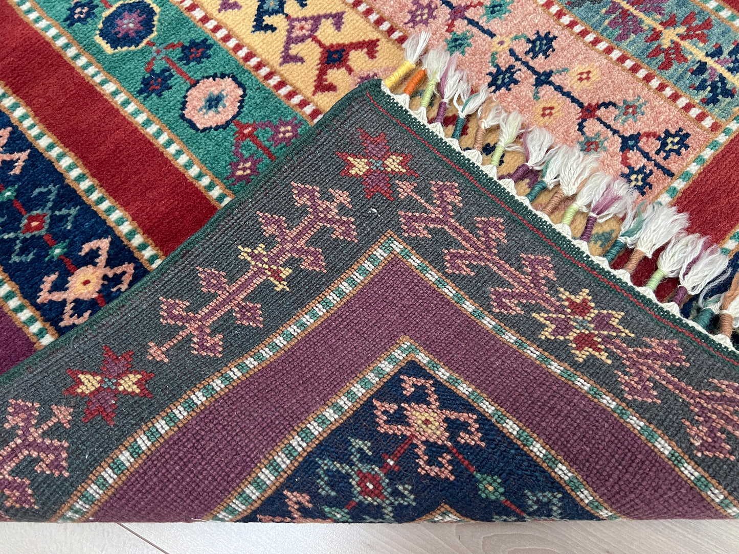 Handmade Turkish Shawl Rug with vibrant vertical stripes in purple, green, red, and mustard. 3x5 wool rug crafted from handspun Turkish wool, available in our San Francisco Bay Area store. Perfect for living room, bedroom, entryway, or nursery decor.