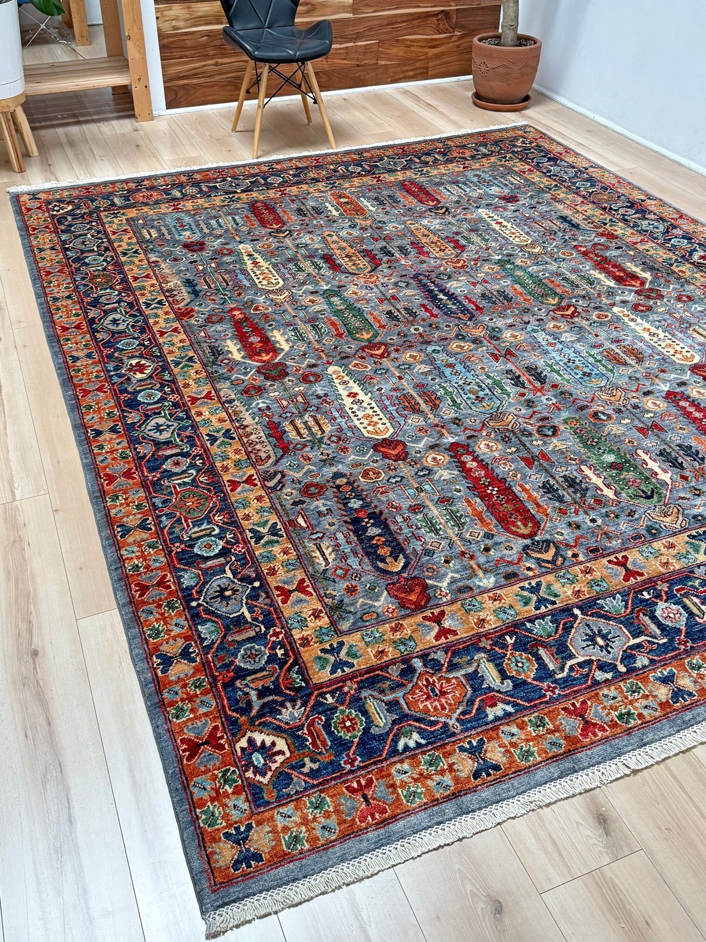 8x10 handmade rug with tribal tree design in sky blue, navy, terracotta, and ivory hues – perfect for bedroom, living room, or dining room décor. High-quality wool rug from the best rug shop in San Mateo, SF Bay Area. Free shipping available. Rich in character and color, ideal for adding warmth and style to your space.