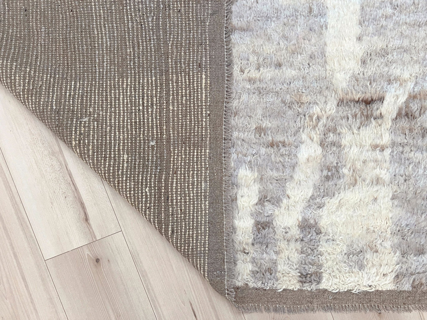 Large neutral Moroccan shag rug 9x12 with high wool pile in ivory and soft taupe tones, minimalist geometric pattern, plush texture ideal for modern living rooms and bedrooms, Indigo Rugs Bay Area