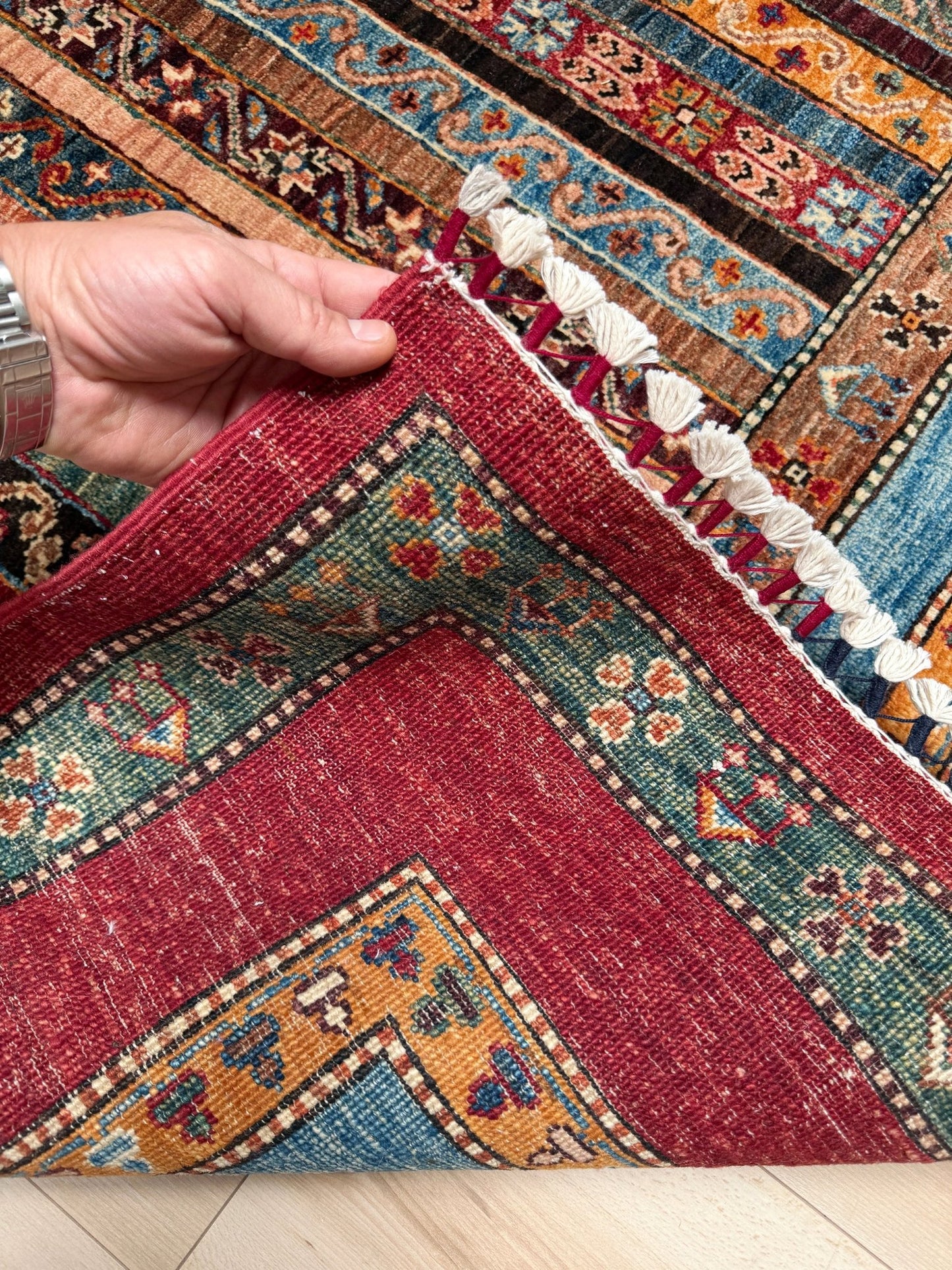 Handmade Turkish shawl rug in almost 7x9 size featuring intricate vertical stripe tribal patterns in crimson red, sky blue, burnt sienna, and olive green. Perfect for living room, bedroom, kitchen, or dining space, and ideal for bohemian, eclectic, traditional, or global-inspired home decor styles. High-quality wool construction with rich earthy tones adds warmth and character to any interior. Available with free shipping from the best rug shop in San Mateo, SF Bay Area.