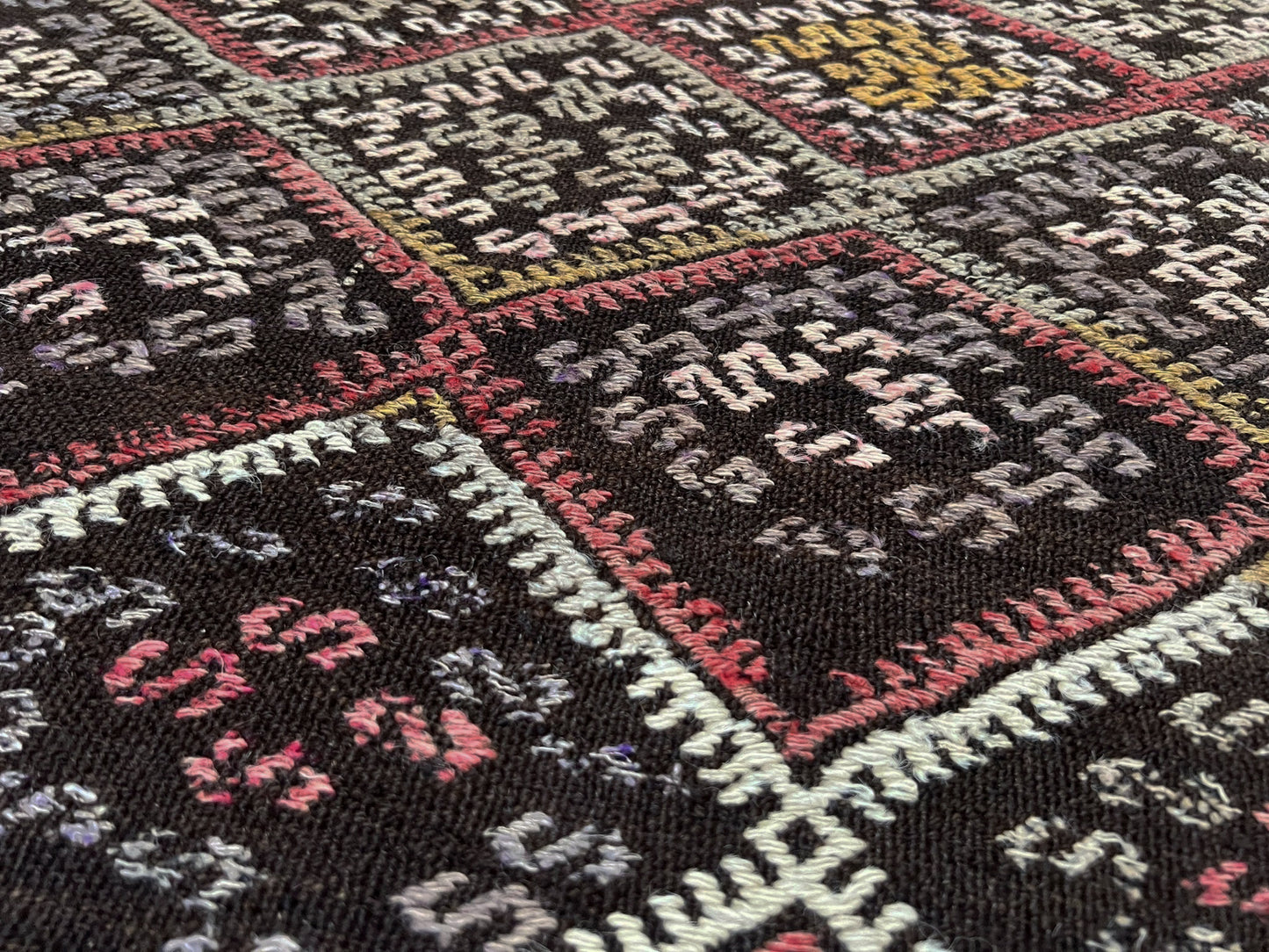4x6 Vintage Malatya Cicim Turkish kilim rug with embroidered diamond motifs in rose, amber, and ivory on a charcoal brown field — handmade wool flatweave from the 1940s, available at Indigo Rugs, the best rug shop in San Francisco Bay Area, Burlingame CA.