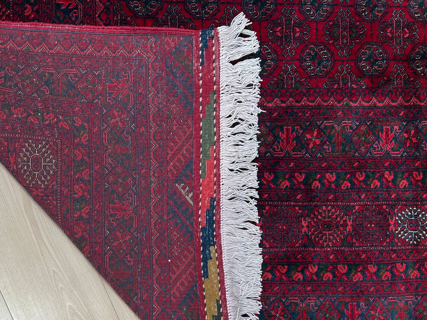 Traditional Turkmen Khoja Roshnai rug with crimson field, repeating gul motifs, navy borders, handmade merino wool area rug 7x10 with velvety pile from Indigo Rugs Burlingame Bay Area.