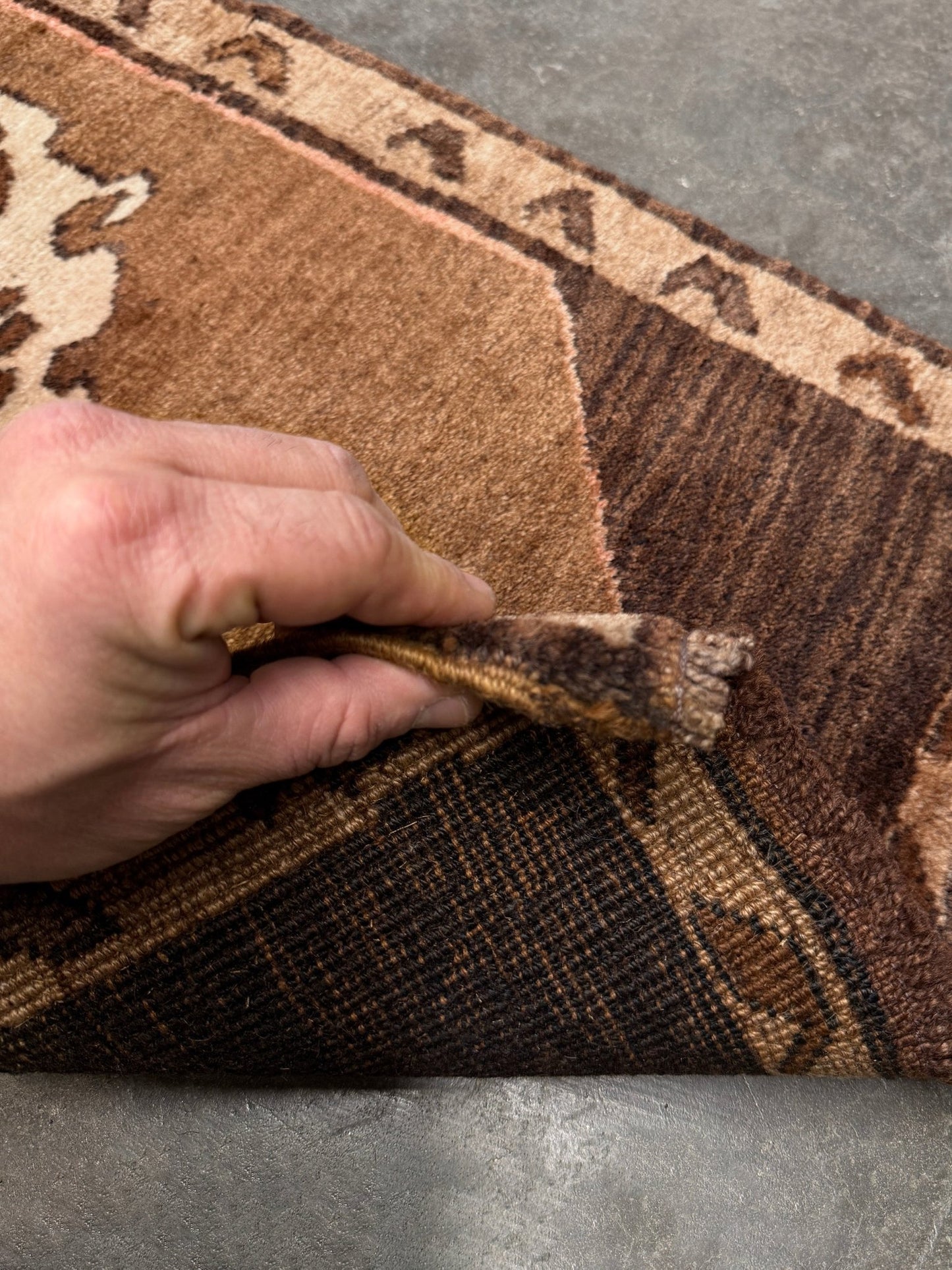 Decorative neutral vintage Turkish mini rug yastik 2x3 made from undyed handspun sheep wool, featuring natural brown and ivory tones with a subtle red accent, geometric medallion design. From Indigo Rugs, Burlingame — the best rug shop in the San Francisco Bay Area. Free shipping.