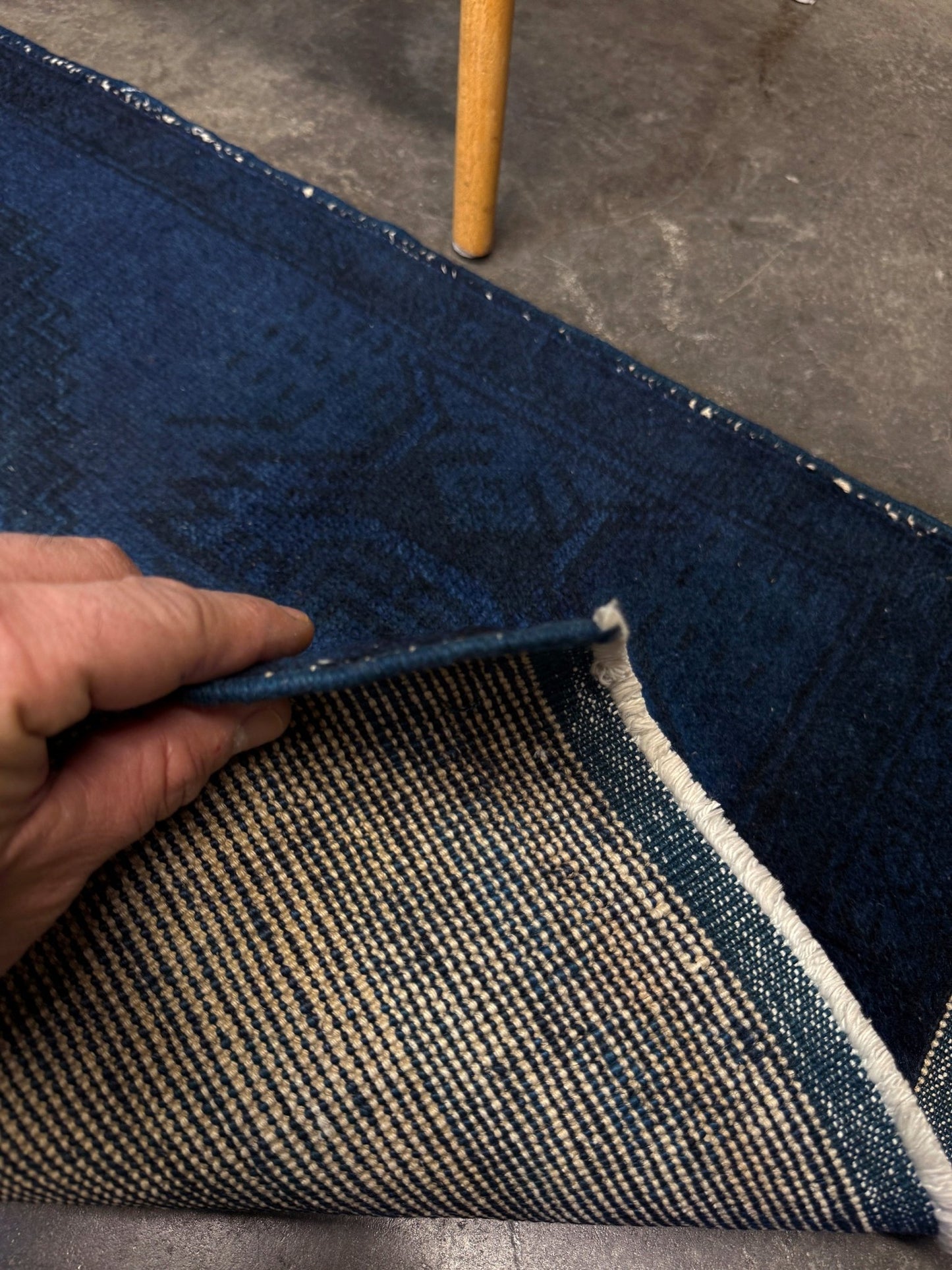 Turkish overdyed Yastik rug in deep indigo and midnight blue, with subtle tribal motifs visible beneath the saturated overdye. Hand-knotted wool, 20x40 inches. One-of-a-kind piece from Indigo Rugs, the best rug shop in the San Francisco Bay Area (Burlingame, CA). Free shipping included.