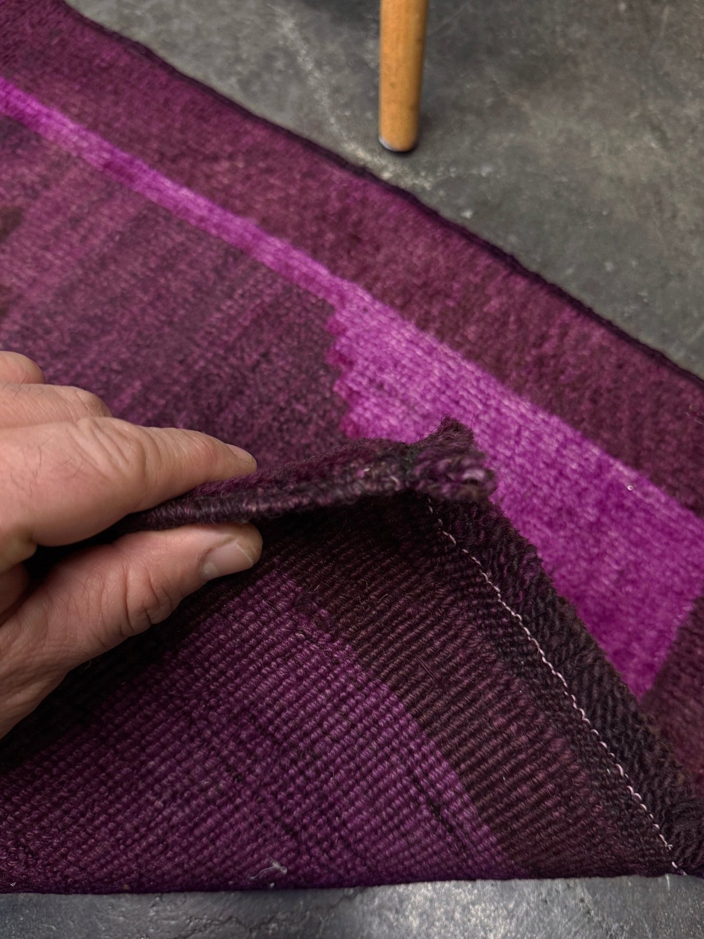 Magenta Purple Turkish mini rug with deep plum purple field, aubergine and blackberry shading, soft magenta border glow, and subtle geometric medallion. Handmade wool rug measuring 18 × 38 inches, perfect for entryways, kitchens, bedside spaces, or layered interiors.