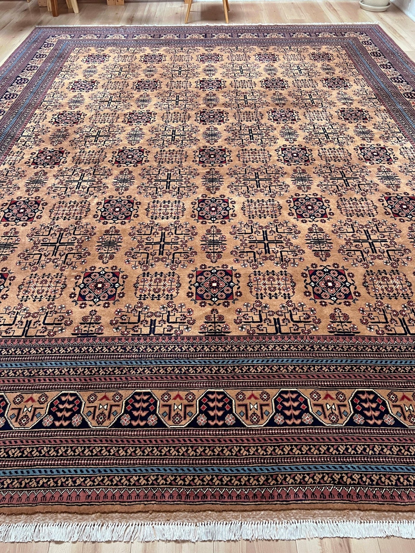 Sand Bilcik Turkmen wool area rug with intricate medallion motifs and ornate indigo and rust borders, perfect for living room, bedroom, or dining room decor. Sold by the best handmade luxury rug shop in the San Francisco Bay Area.