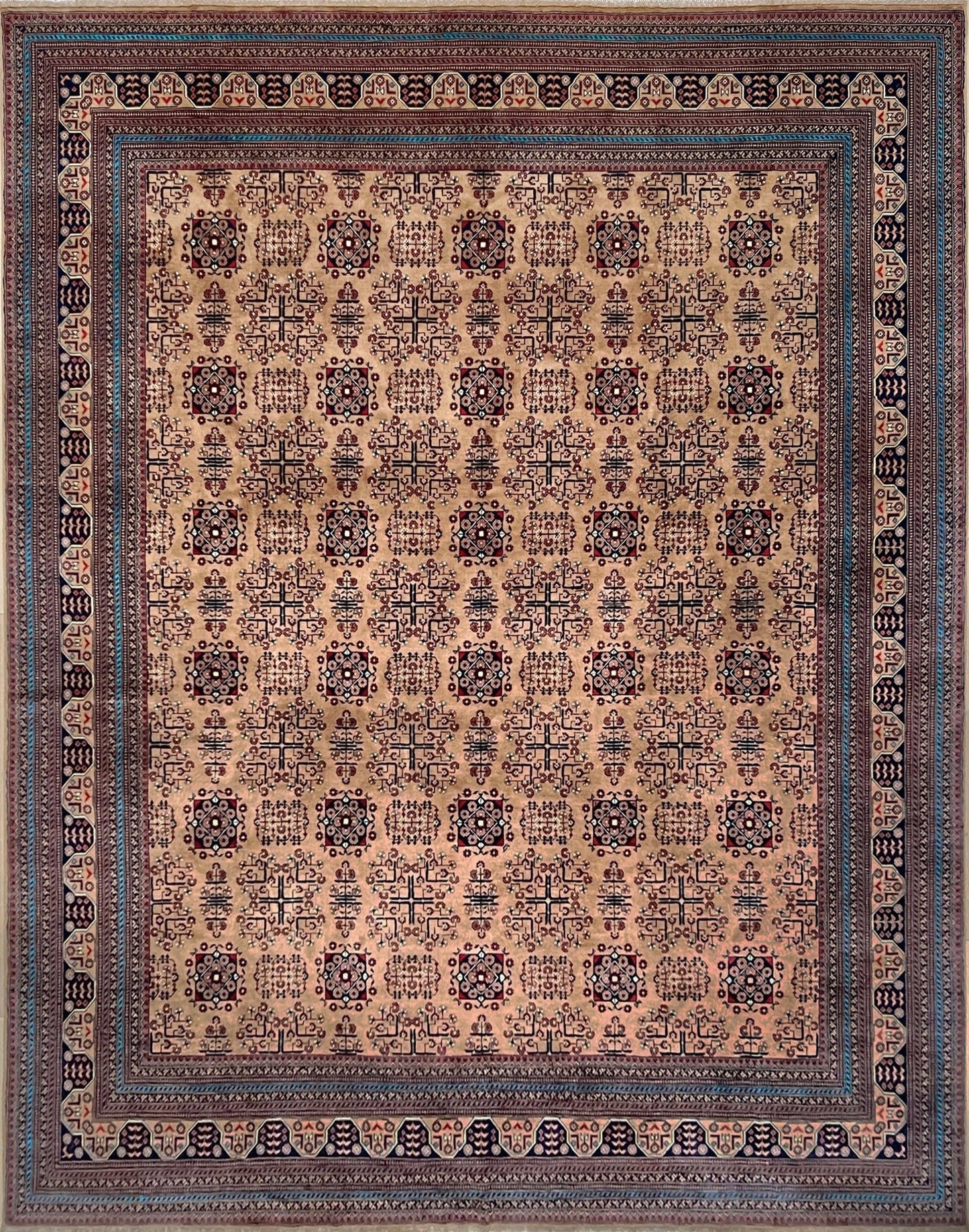 Sand Bilcik Turkmen wool area rug with intricate medallion motifs and ornate indigo and rust borders, perfect for living room, bedroom, or dining room decor. Sold by the best handmade luxury rug shop in the San Francisco Bay Area.