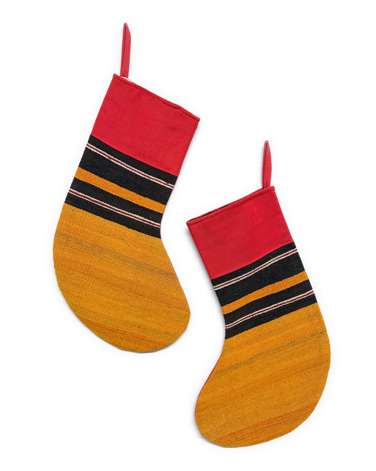 Two Christmas stockings with a striped pattern in red, black, and yellow, shown on a plain white background.