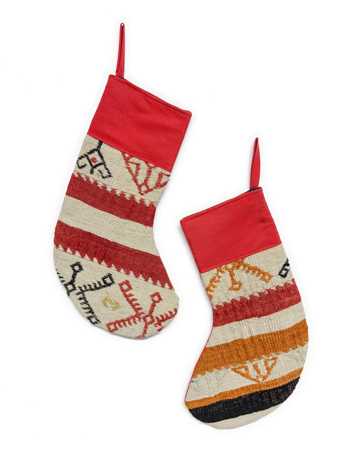 Two handwoven Christmas stockings with Southwestern geometric patterns, displayed on a clean white background. One stocking features a red cuff and red, orange, and beige stripes with a gold anchor motif.