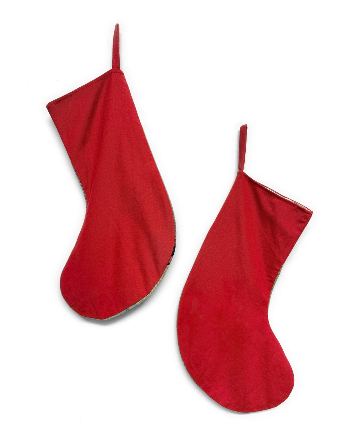 Two handwoven Christmas stockings with Southwestern geometric patterns, displayed on a clean white background. One stocking features a red cuff and red, orange, and beige stripes with a gold anchor motif.