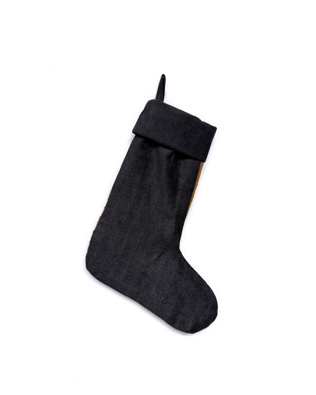 A handmade Kilim Christmas stocking featuring a Southwestern geometric pattern in brown, terracotta, yellow, and black, with a black ribbed cuff and hanging loop.