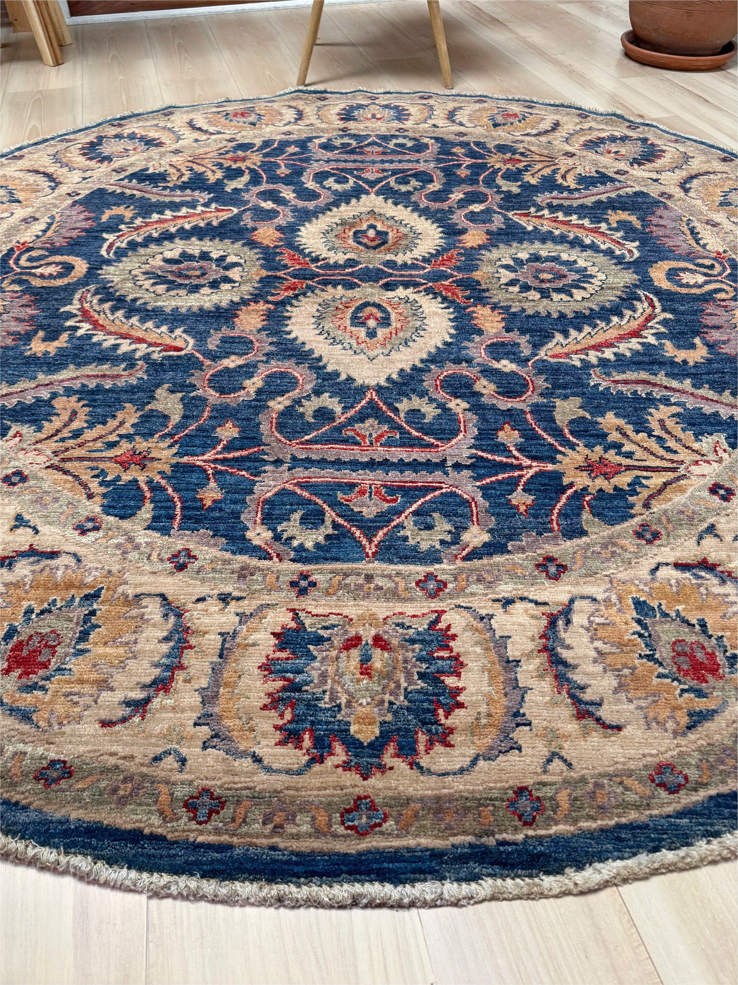 Round Oushak rug with blue field, beige border, muted gold, dusty red floral details, handmade wool 6x6 round area rug from Indigo Rugs Burlingame Bay Area.
