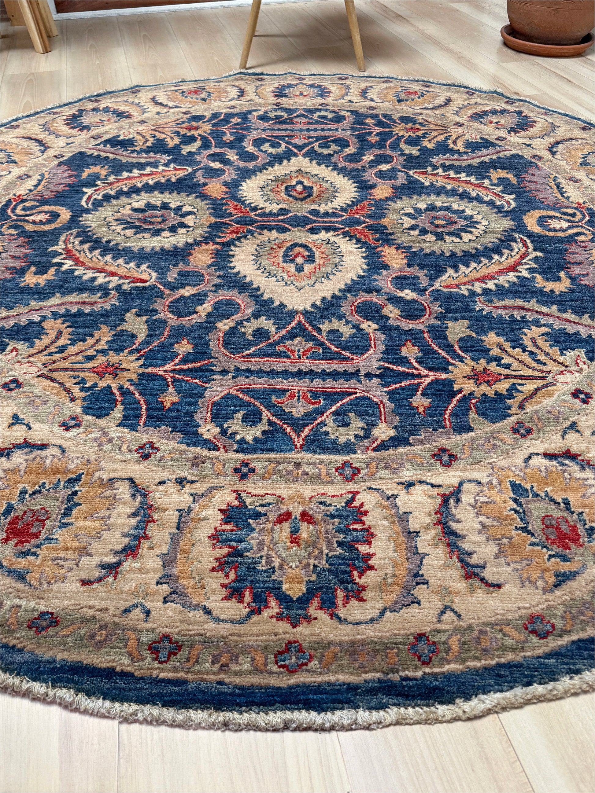 Round Oushak rug with blue field, beige border, muted gold, dusty red floral details, handmade wool 6x6 round area rug from Indigo Rugs Burlingame Bay Area.
