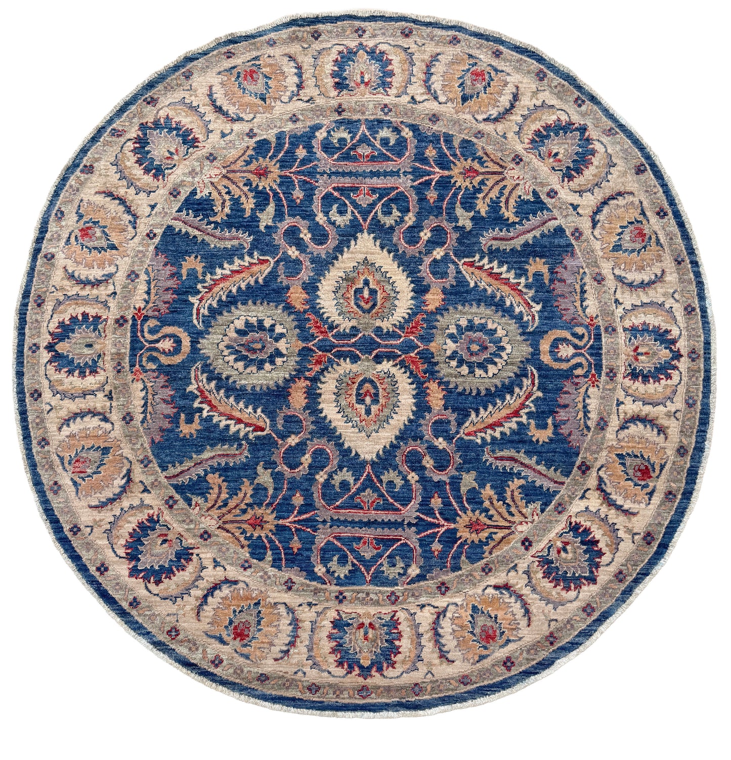 Round decorative rug with intricate paisley pattern on a white background. Round Oushak rug with blue field, beige border, muted gold, dusty red floral details, handmade wool 6x6 round area rug from Indigo Rugs Burlingame Bay Area.