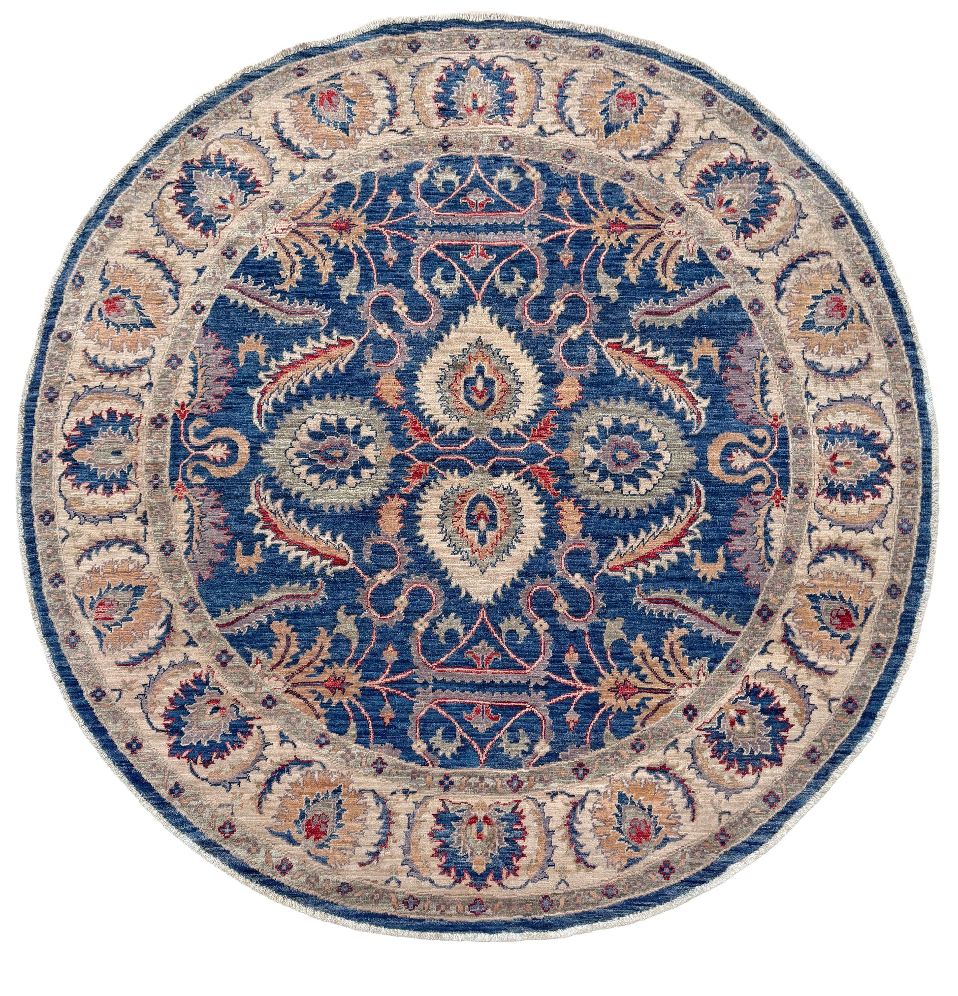 Round decorative rug with intricate paisley pattern on a white background. Round Oushak rug with blue field, beige border, muted gold, dusty red floral details, handmade wool 6x6 round area rug from Indigo Rugs Burlingame Bay Area.