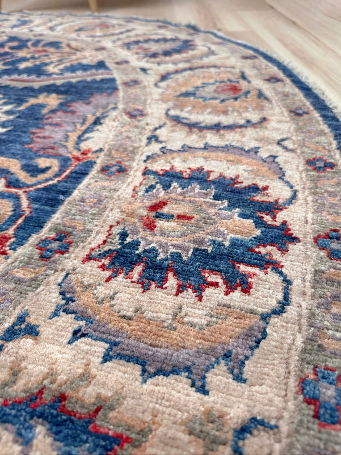 Round Oushak rug with blue field, beige border, muted gold, dusty red floral details, handmade wool 6x6 round area rug from Indigo Rugs Burlingame Bay Area.