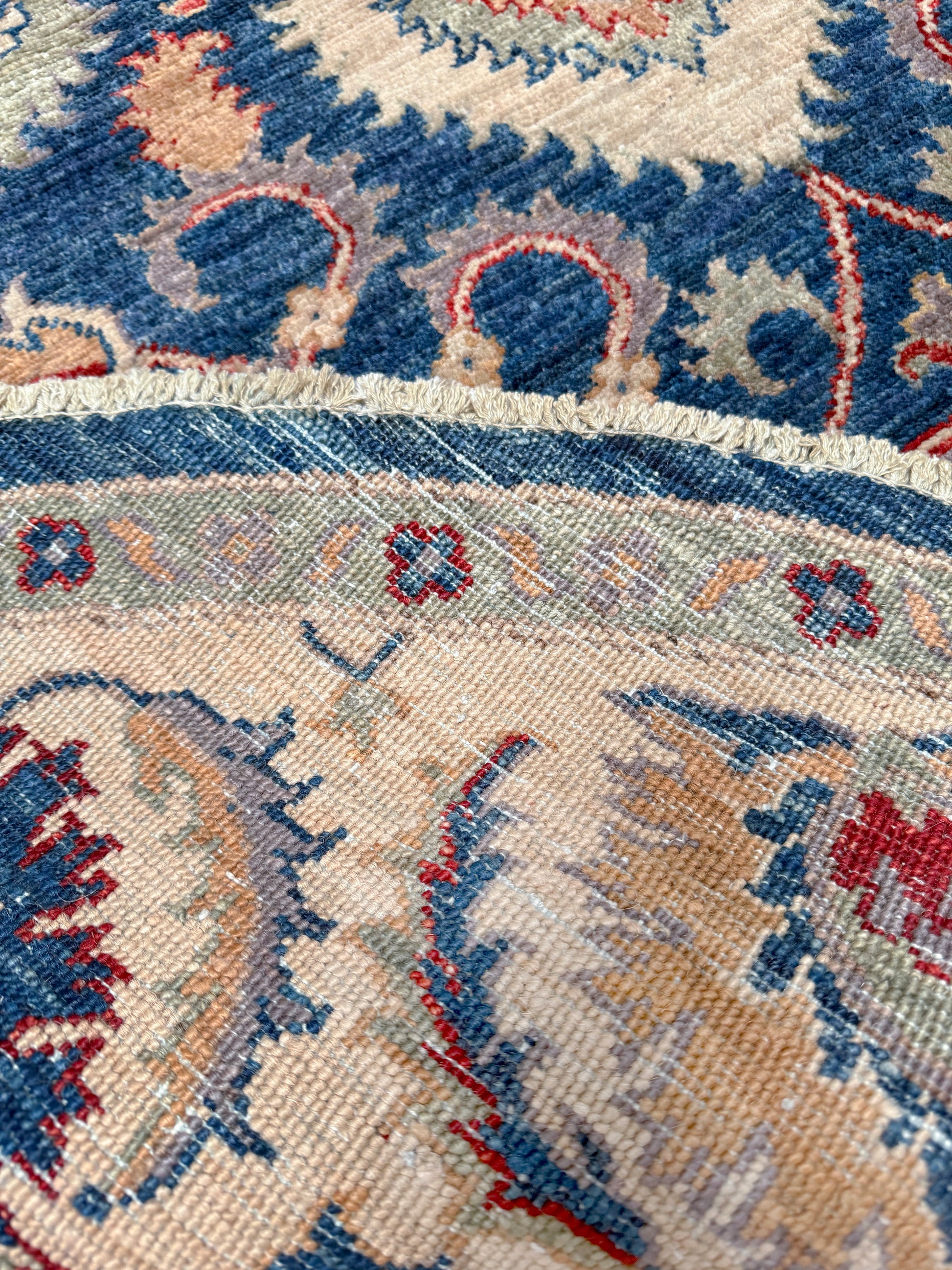 Round Oushak rug with blue field, beige border, muted gold, dusty red floral details, handmade wool 6x6 round area rug from Indigo Rugs Burlingame Bay Area.