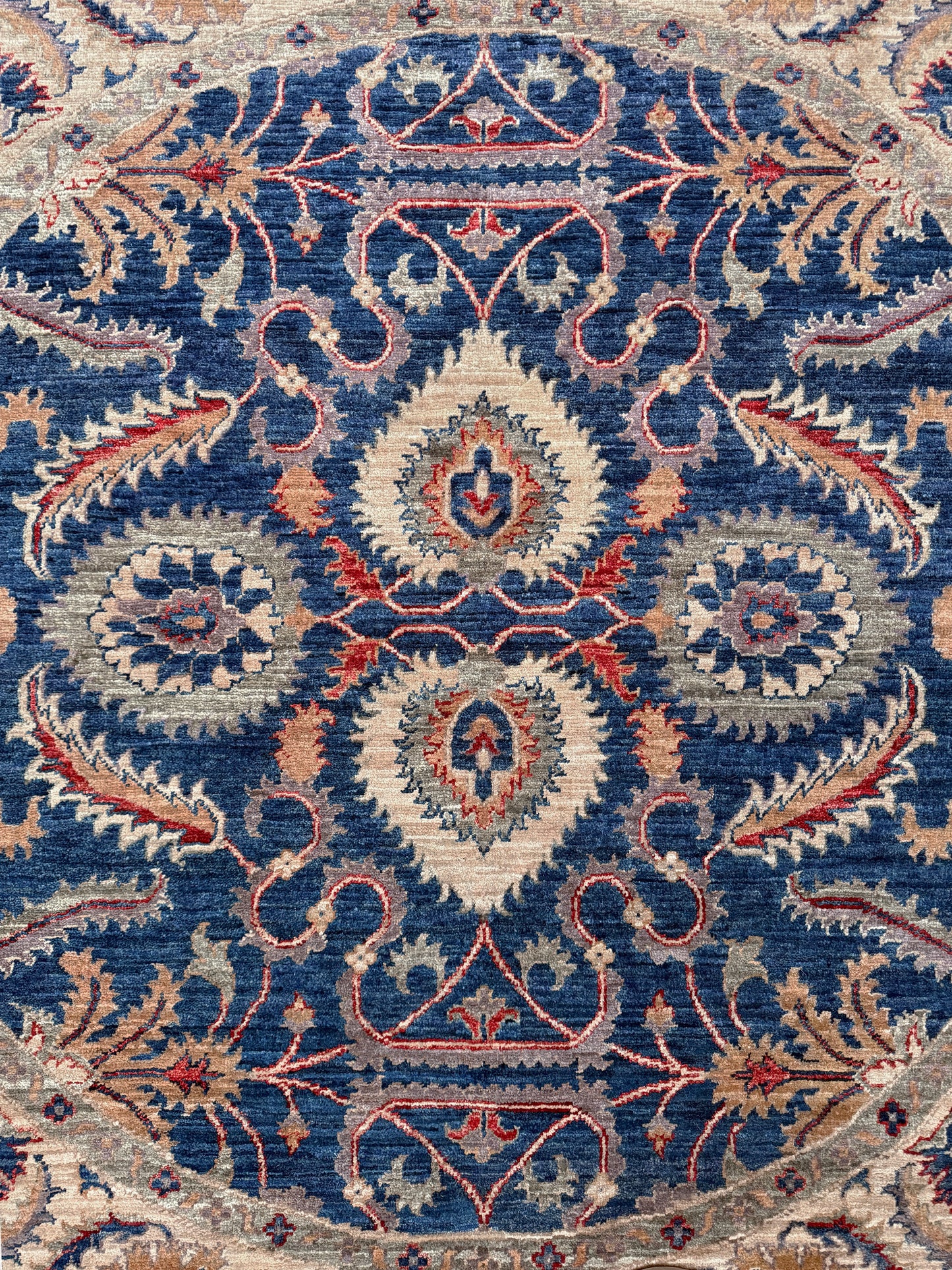 Round Oushak rug with blue field, beige border, muted gold, dusty red floral details, handmade wool 6x6 round area rug from Indigo Rugs Burlingame Bay Area.