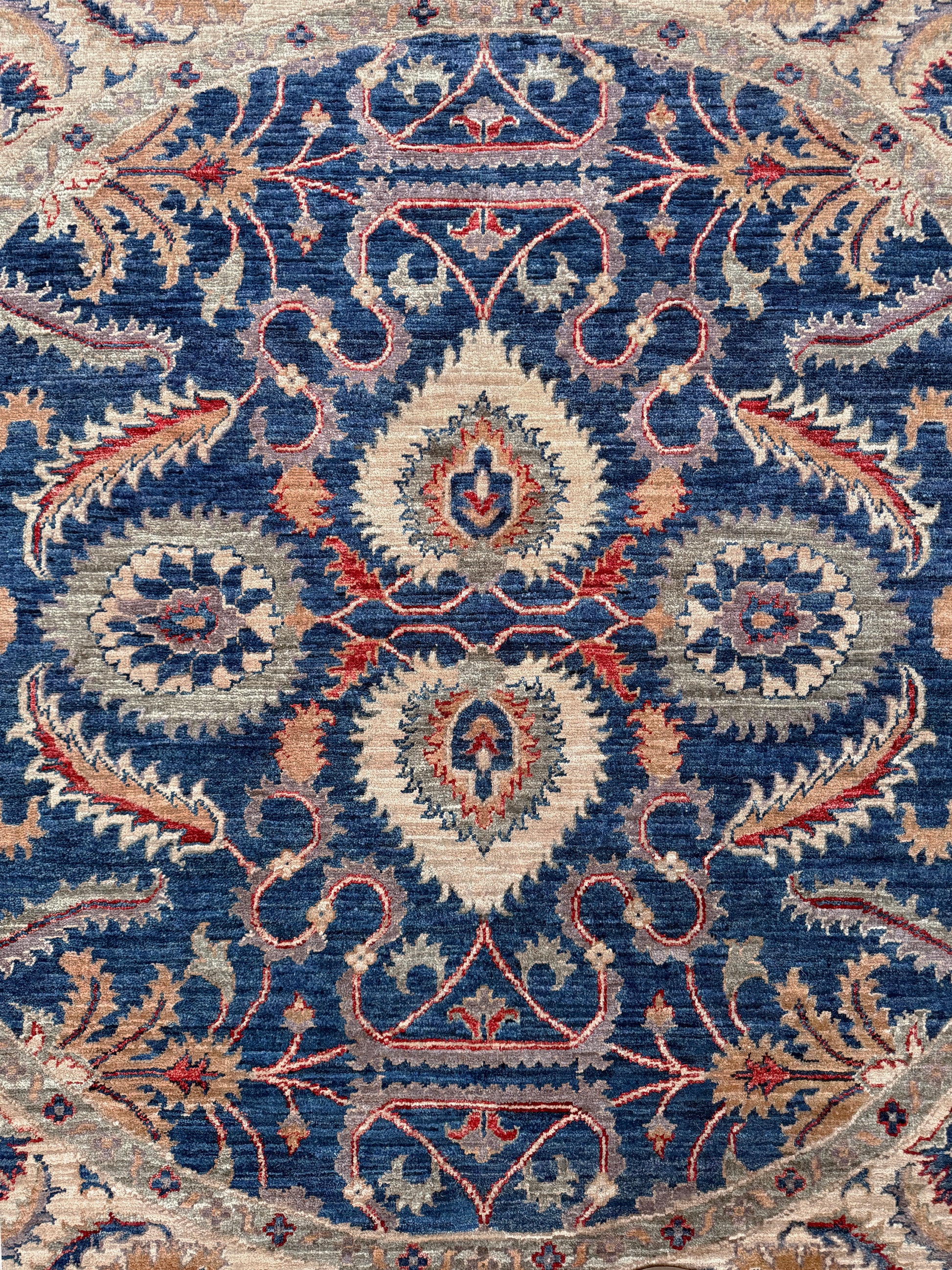 Round Oushak rug with blue field, beige border, muted gold, dusty red floral details, handmade wool 6x6 round area rug from Indigo Rugs Burlingame Bay Area.