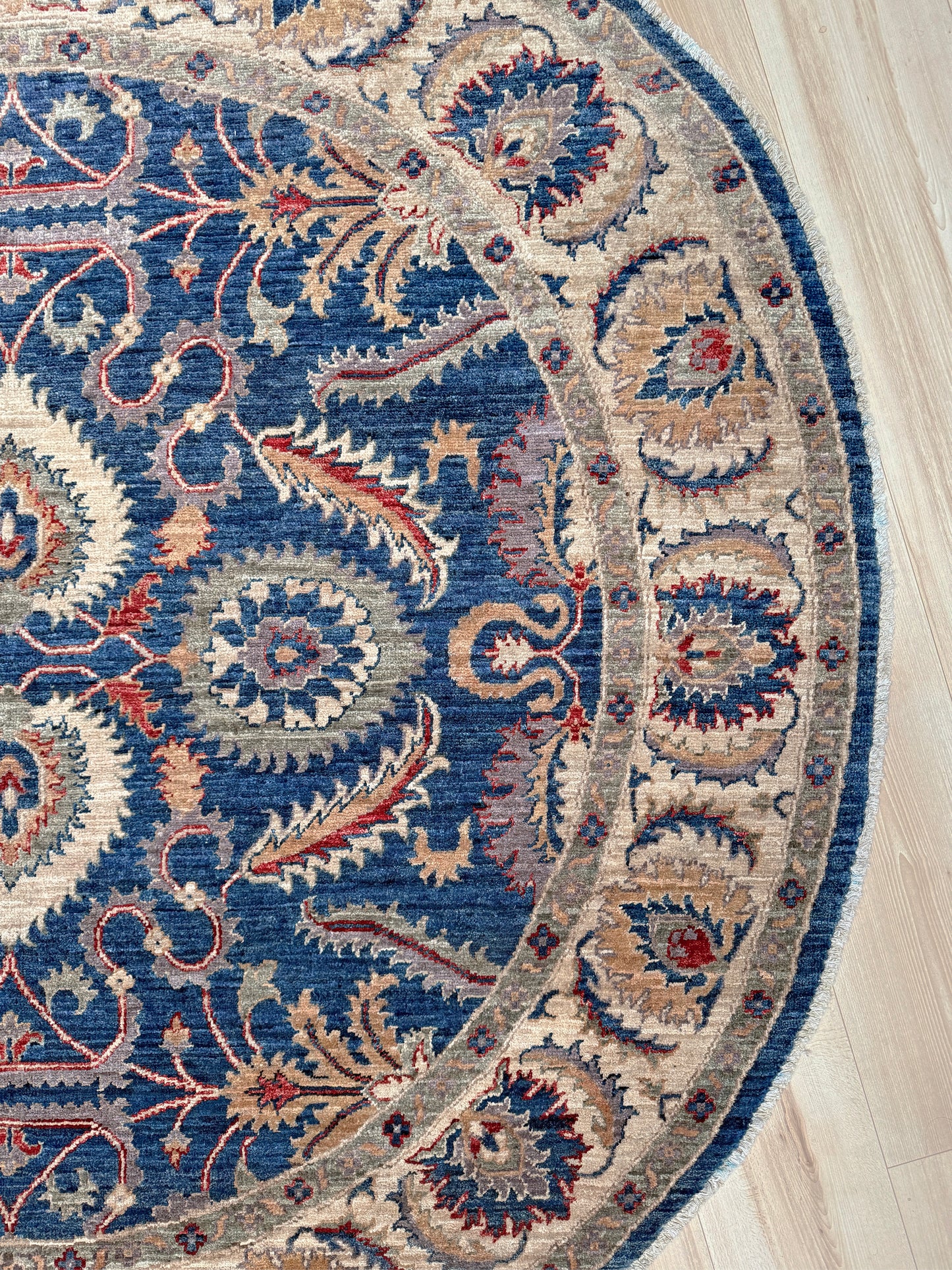 Round Oushak rug with blue field, beige border, muted gold, dusty red floral details, handmade wool 6x6 round area rug from Indigo Rugs Burlingame Bay Area.