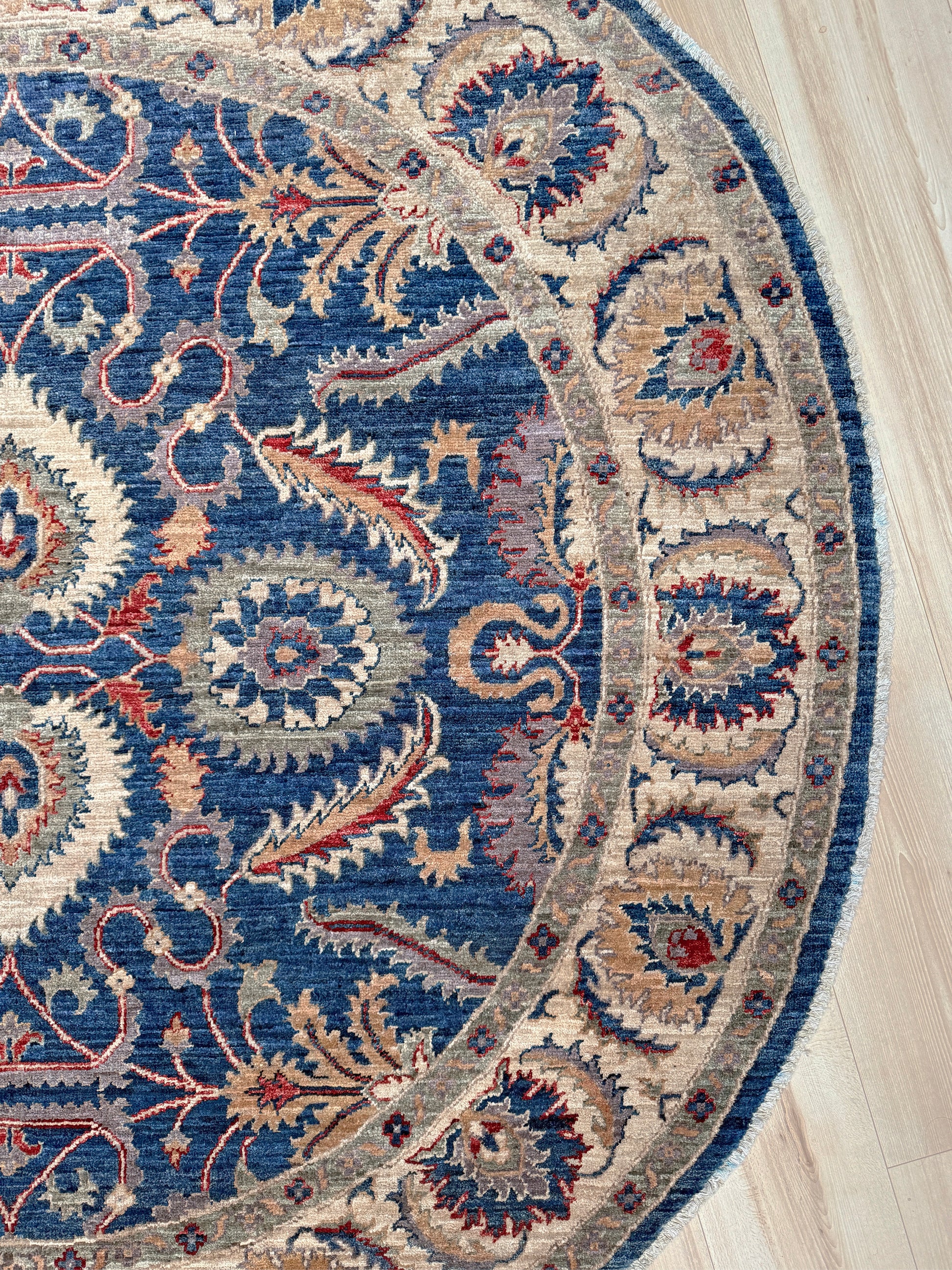 Round Oushak rug with blue field, beige border, muted gold, dusty red floral details, handmade wool 6x6 round area rug from Indigo Rugs Burlingame Bay Area.