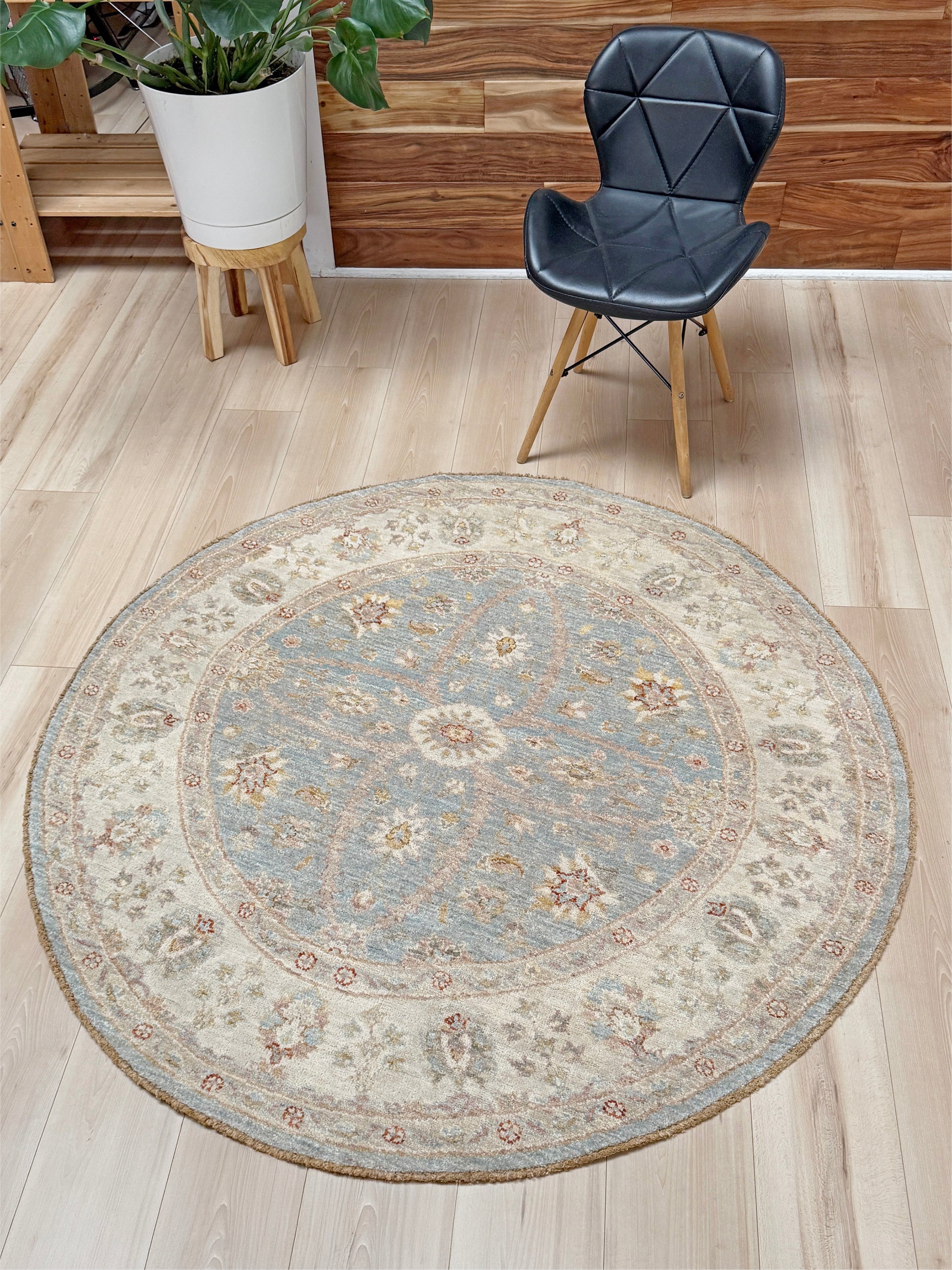 Pale blue round Turkish Oushak rug with soft colored floral details, handmade wool 5x5 round area rug from Indigo Rugs Burlingame Bay Area.
