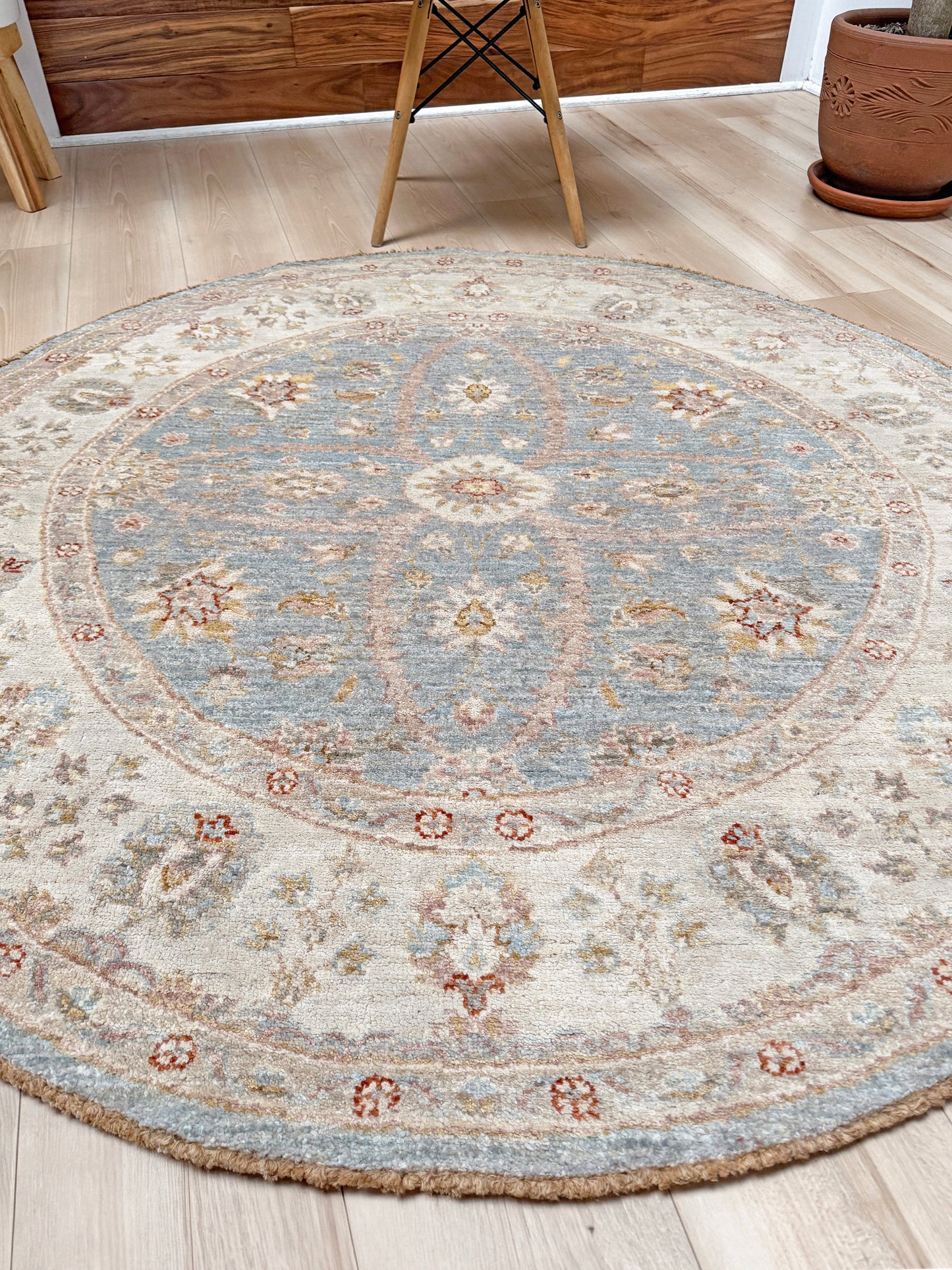 Pale blue round Turkish Oushak rug with ivory, sand beige, taupe, dusty rose floral details, handmade wool 5x5 round area rug from Indigo Rugs Burlingame Bay Area.