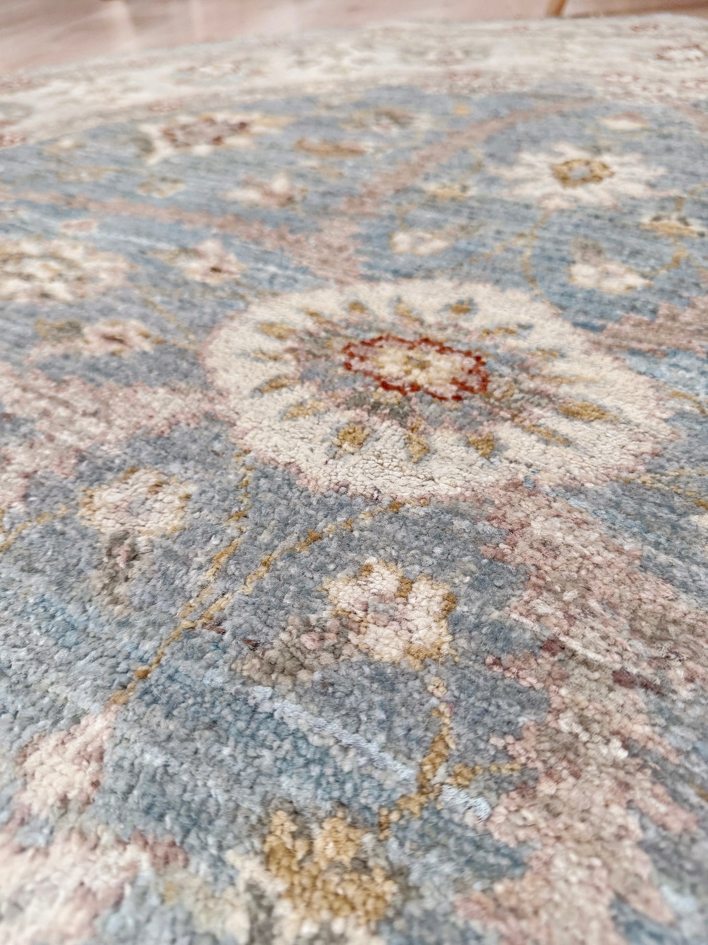 Pale blue round Turkish Oushak rug with ivory, sand beige, taupe, dusty rose floral details, handmade wool 5x5 round area rug from Indigo Rugs Burlingame Bay Area.