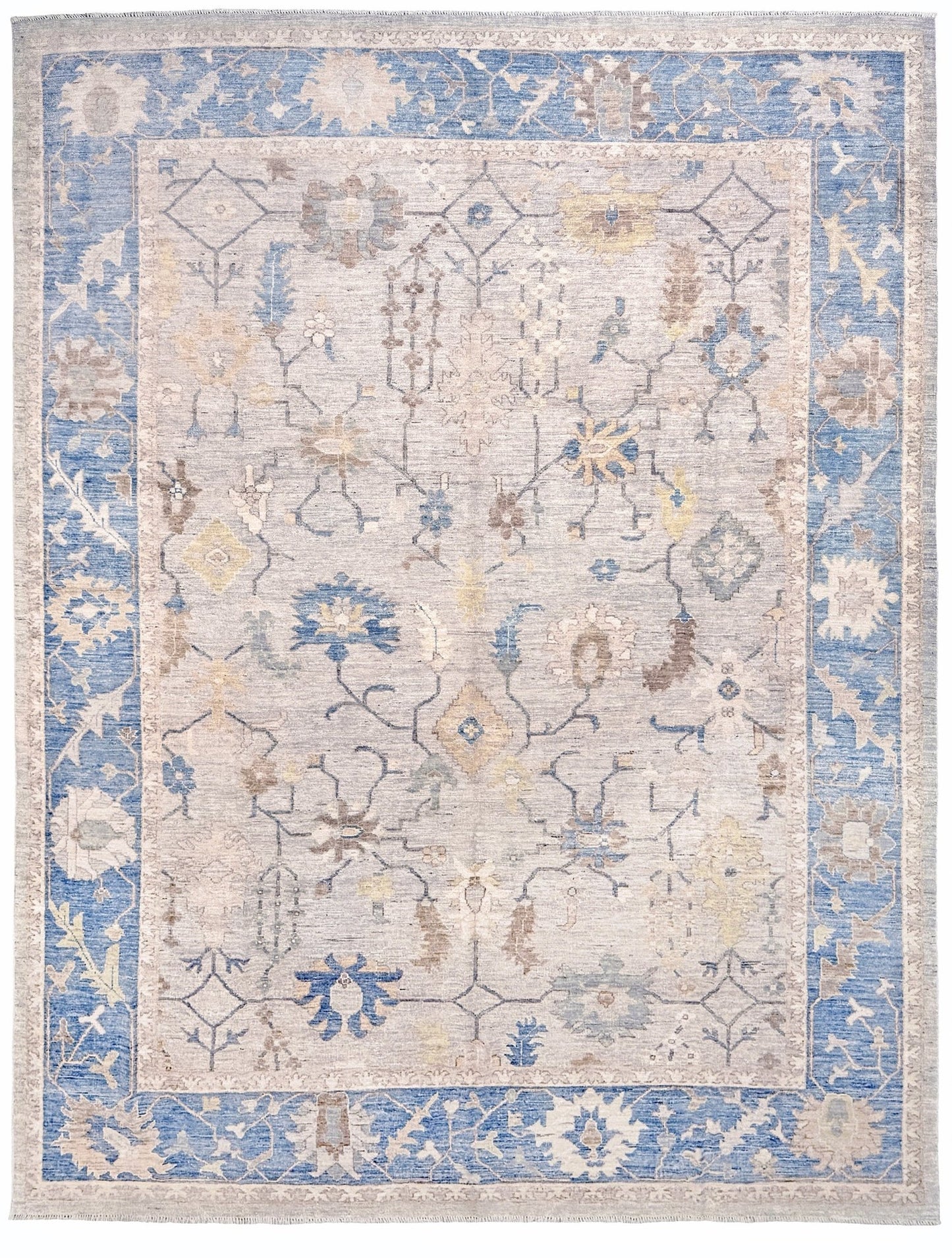 Brand new Turkish Oushak rug with soft ivory field, pale blue border, faded floral motifs, handmade wool area rug 9x12 from Indigo Rugs Burlingame Bay Area.