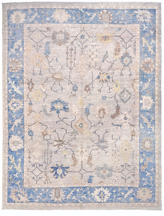 Brand new Turkish Oushak rug with soft ivory field, pale blue border, faded floral motifs, handmade wool area rug 9x12 from Indigo Rugs Burlingame Bay Area.