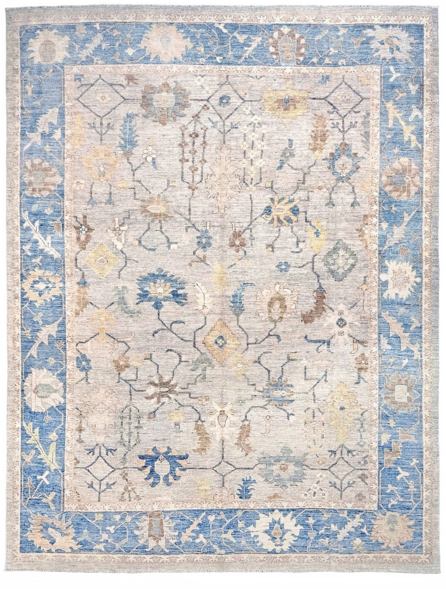 Brand new Turkish Oushak rug with soft ivory field, pale blue border, faded floral motifs, handmade wool area rug 9x12 from Indigo Rugs Burlingame Bay Area.