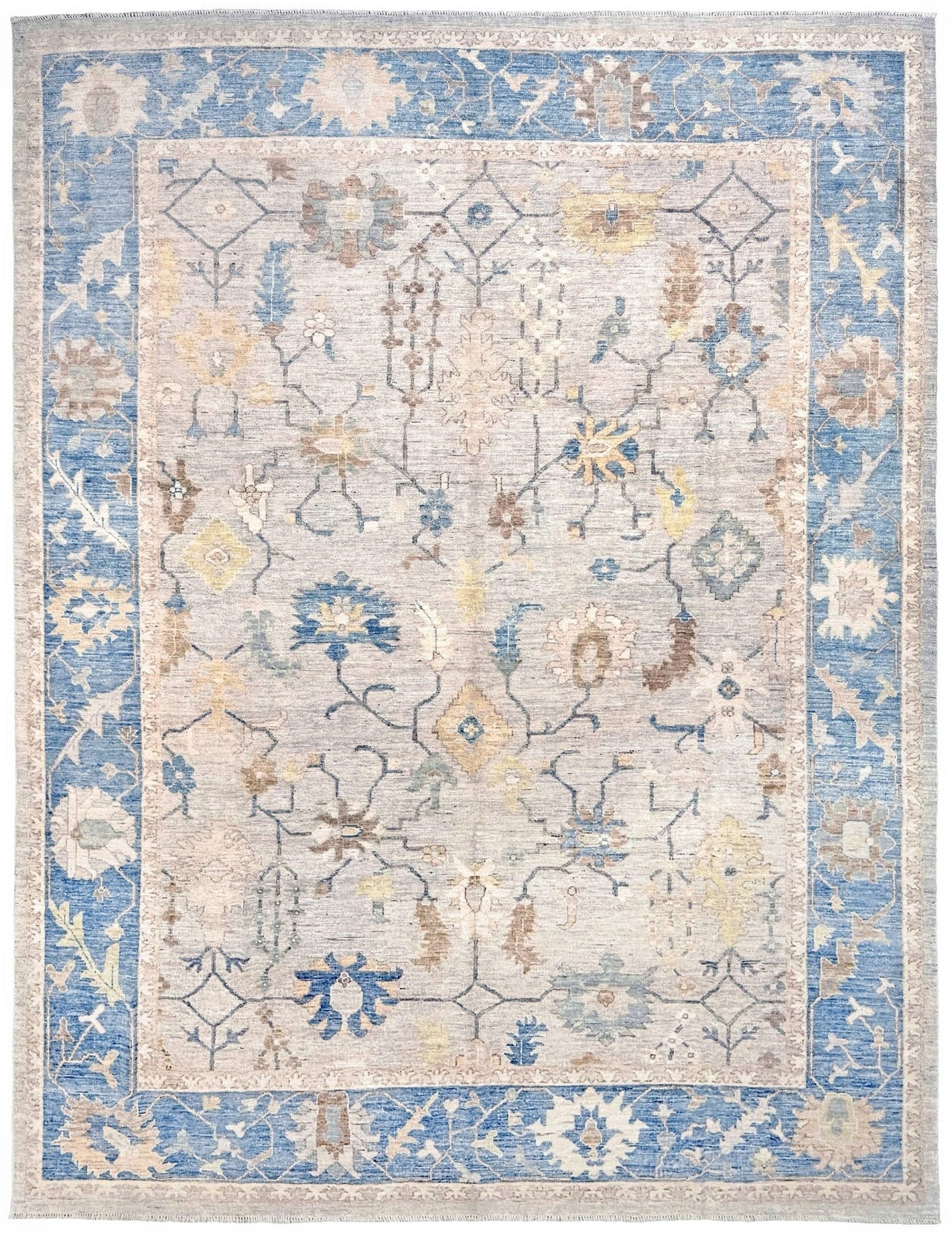 Brand new Turkish Oushak rug with soft ivory field, pale blue border, faded floral motifs, handmade wool area rug 9x12 from Indigo Rugs Burlingame Bay Area.