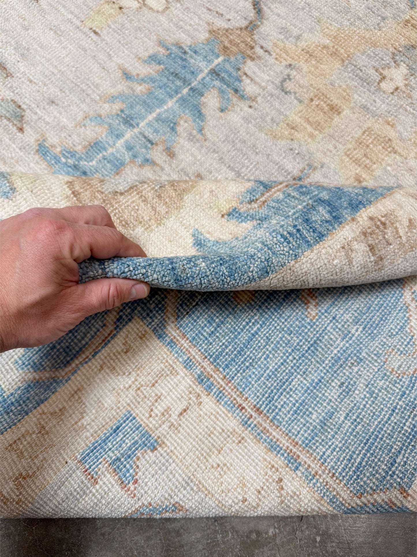 Brand new Turkish Oushak rug with soft ivory field, pale blue border, faded floral motifs, handmade wool area rug 9x12 from Indigo Rugs Burlingame Bay Area.