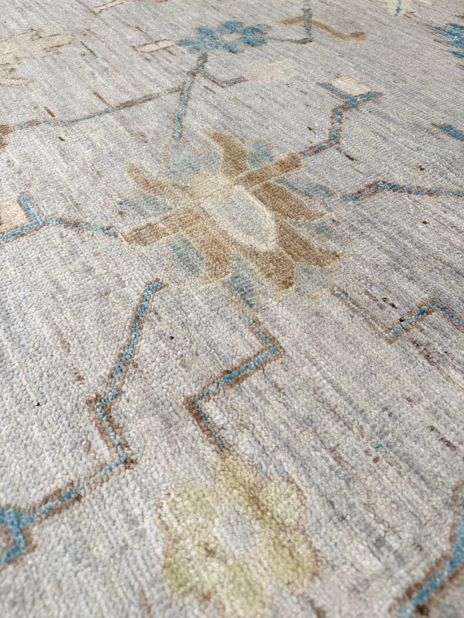 Brand new Turkish Oushak rug with soft ivory field, pale blue border, faded floral motifs, handmade wool area rug 9x12 from Indigo Rugs Burlingame Bay Area.