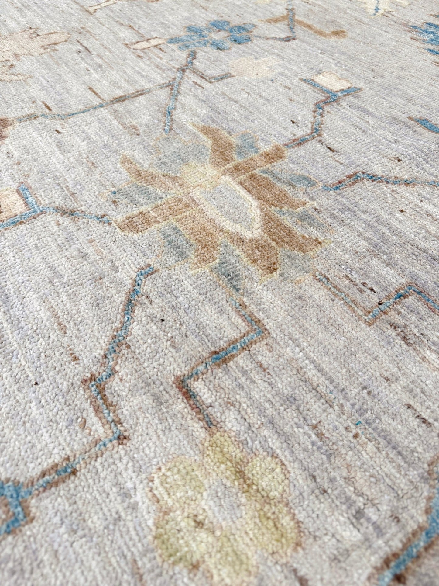 Brand new Turkish Oushak rug with soft ivory field, pale blue border, faded floral motifs, handmade wool area rug 9x12 from Indigo Rugs Burlingame Bay Area.