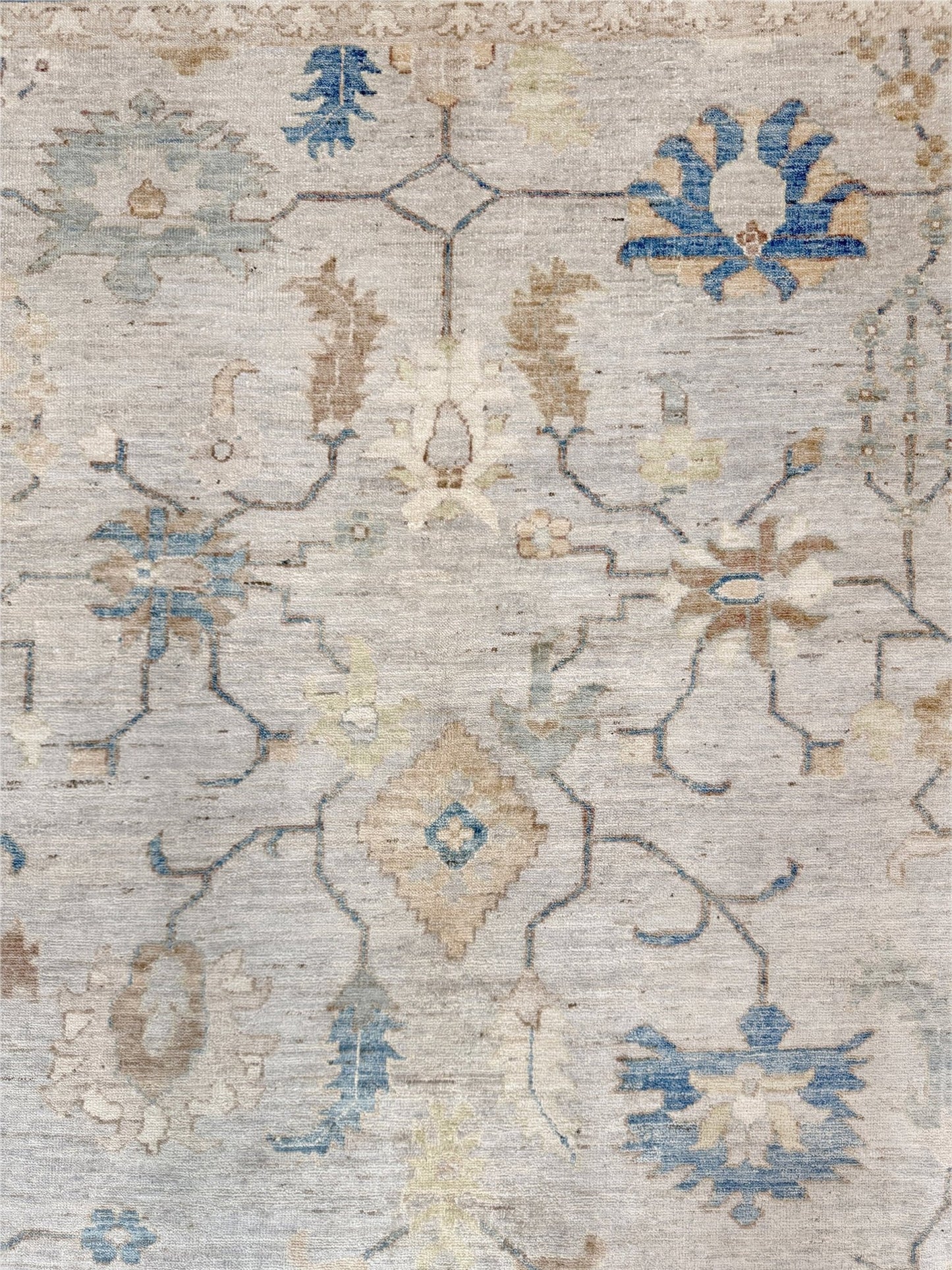 Brand new Turkish Oushak rug with soft ivory field, pale blue border, faded floral motifs, handmade wool area rug 9x12 from Indigo Rugs Burlingame Bay Area.