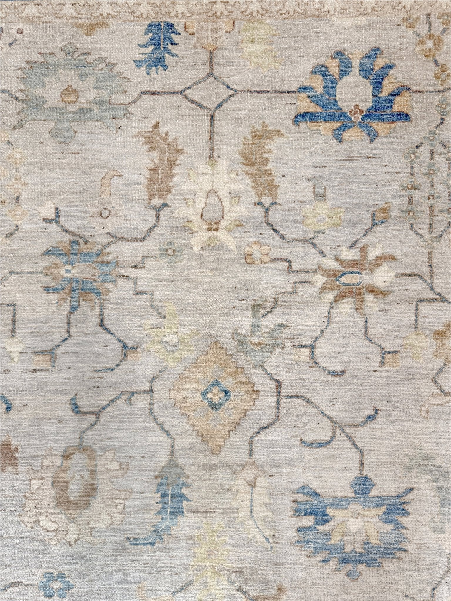 Brand new Turkish Oushak rug with soft ivory field, pale blue border, faded floral motifs, handmade wool area rug 9x12 from Indigo Rugs Burlingame Bay Area.