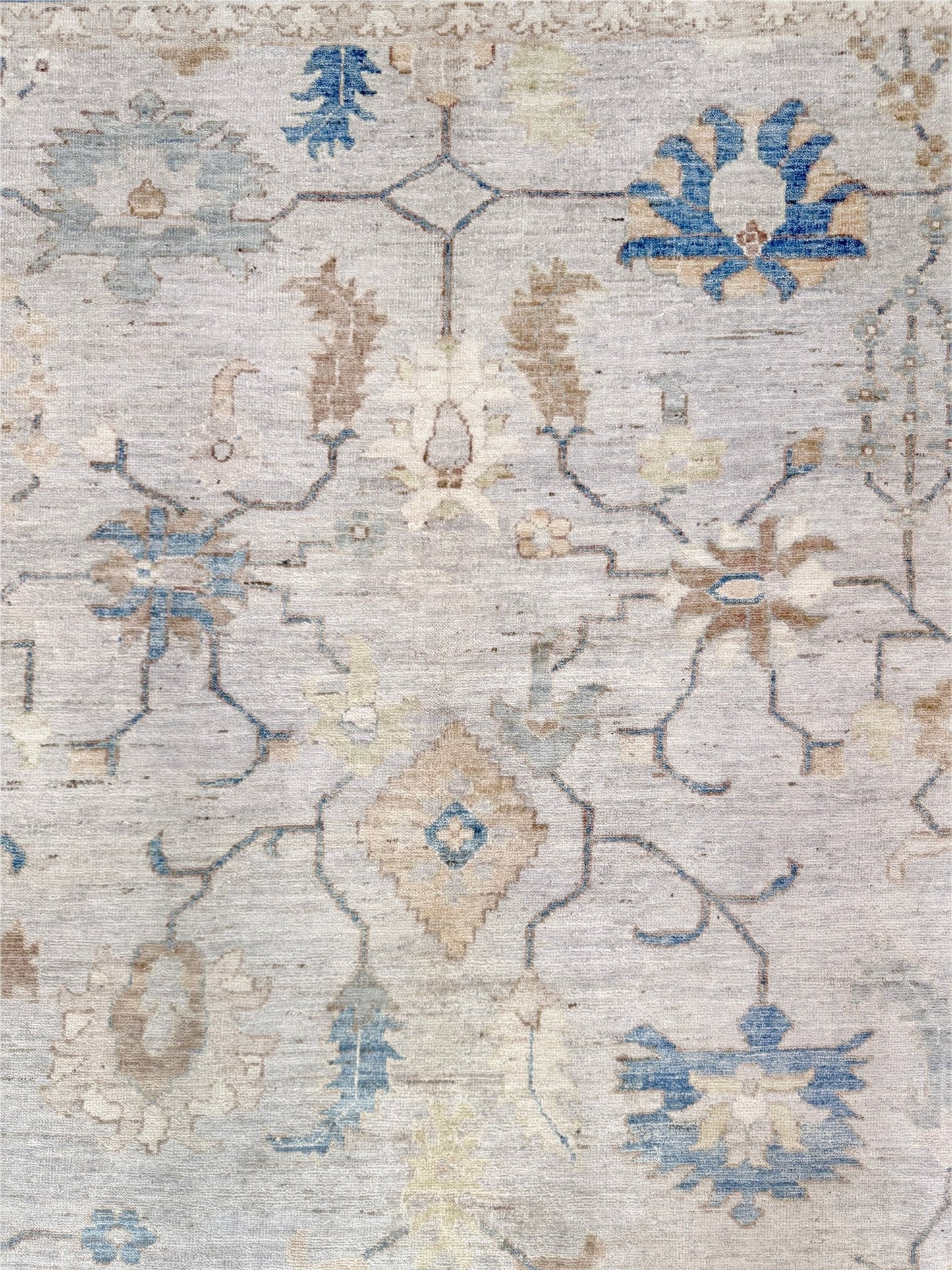 Brand new Turkish Oushak rug with soft ivory field, pale blue border, faded floral motifs, handmade wool area rug 9x12 from Indigo Rugs Burlingame Bay Area.