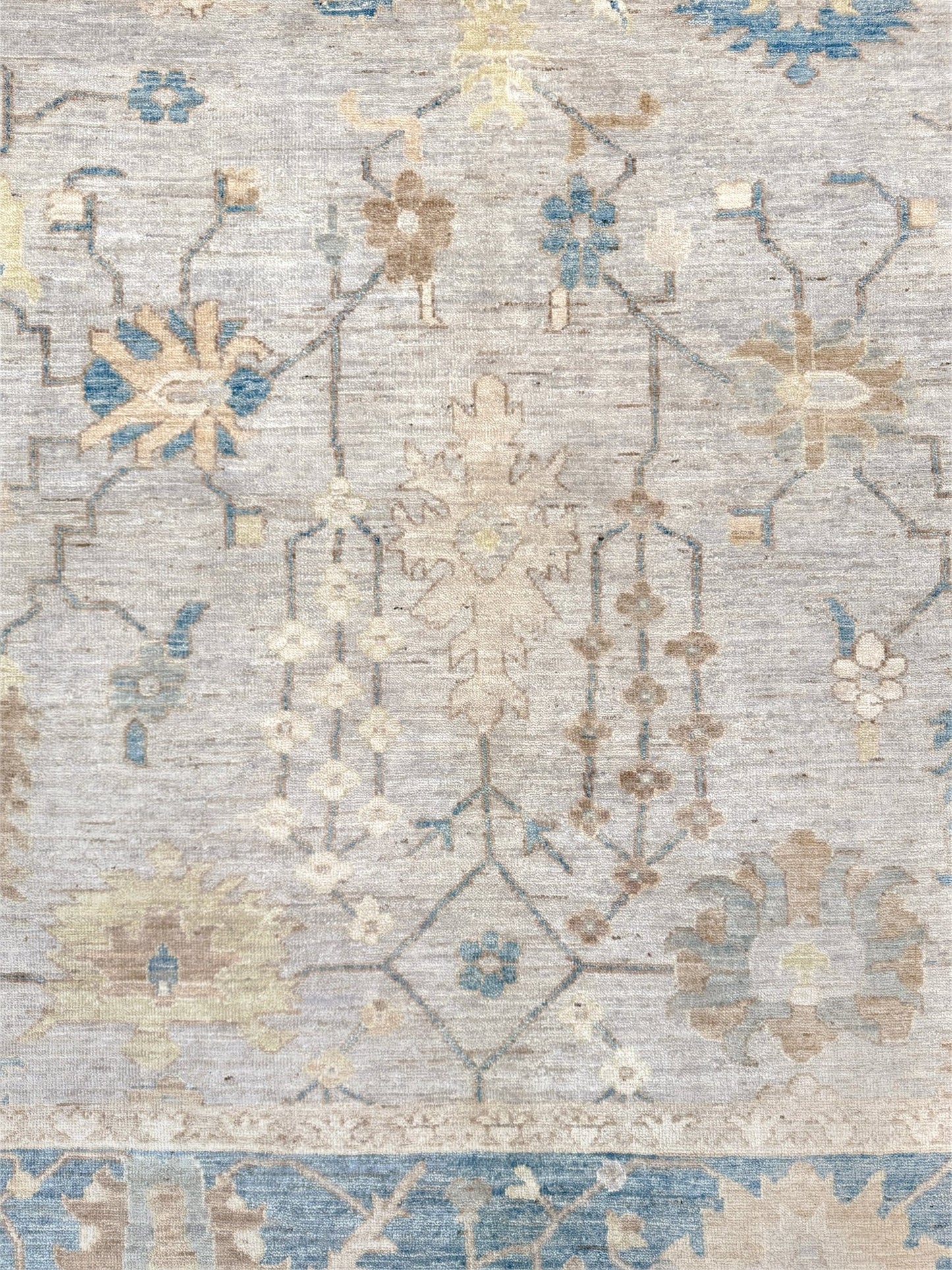 Brand new Turkish Oushak rug with soft ivory field, pale blue border, faded floral motifs, handmade wool area rug 9x12 from Indigo Rugs Burlingame Bay Area.
