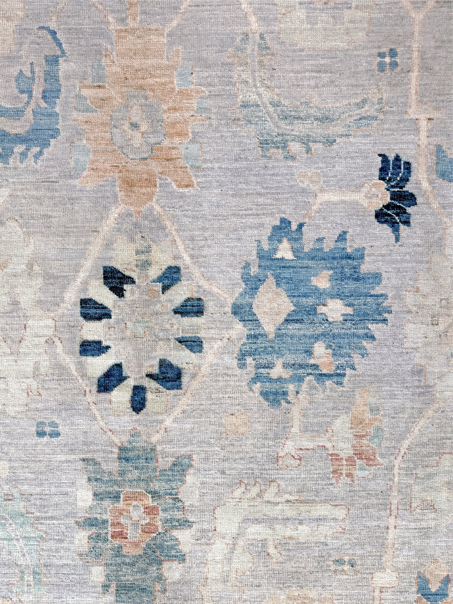 Brand new Turkish Oushak rug with pale blue field, subtle lilac undertones, soft ivory border, faded blue and peach beige accents, handmade wool area rug 9x12 from Indigo Rugs Burlingame Bay Area.