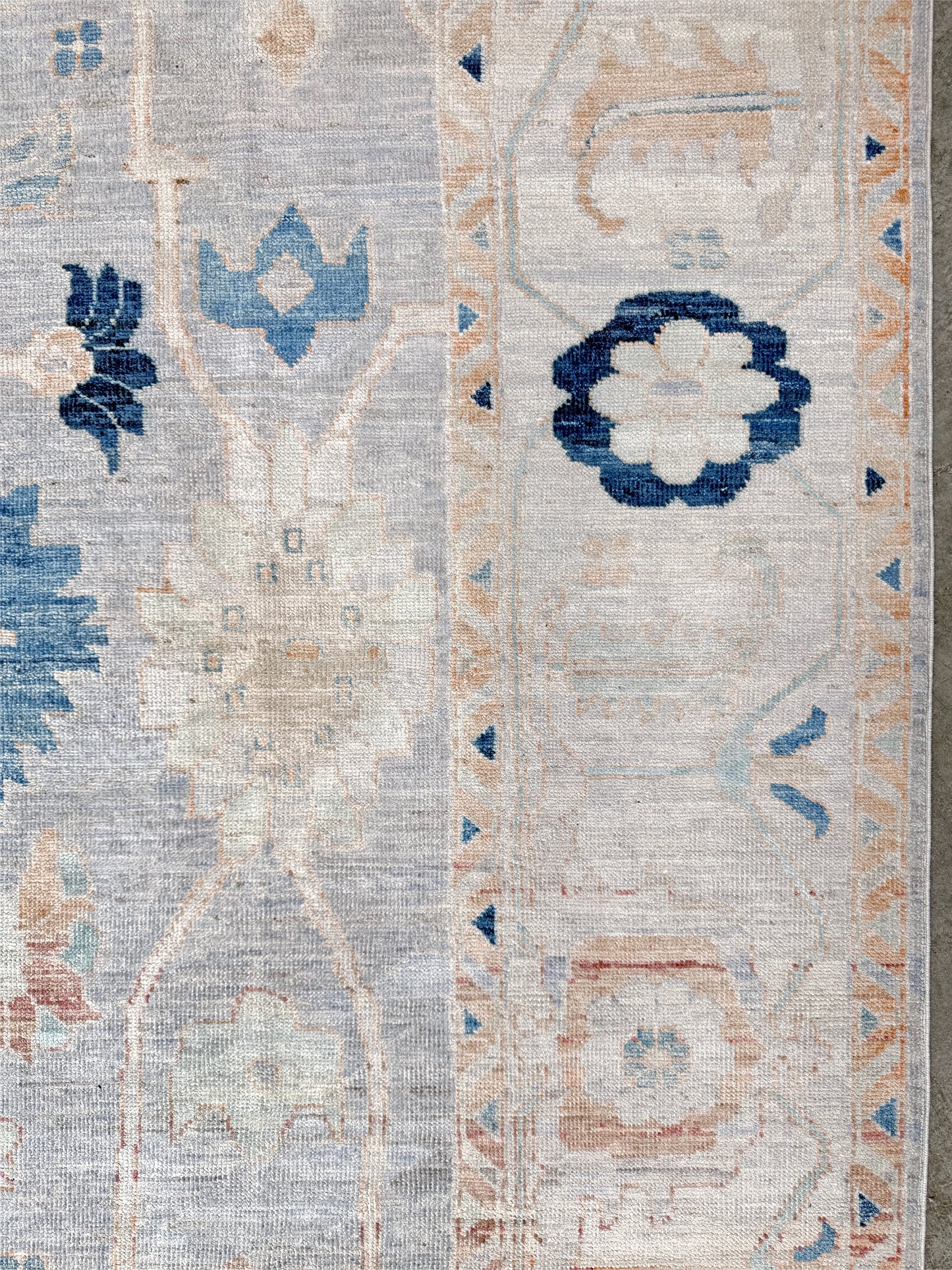 Brand new Turkish Oushak rug with pale blue field, subtle lilac undertones, soft ivory border, faded blue and peach beige accents, handmade wool area rug 9x12 from Indigo Rugs Burlingame Bay Area.