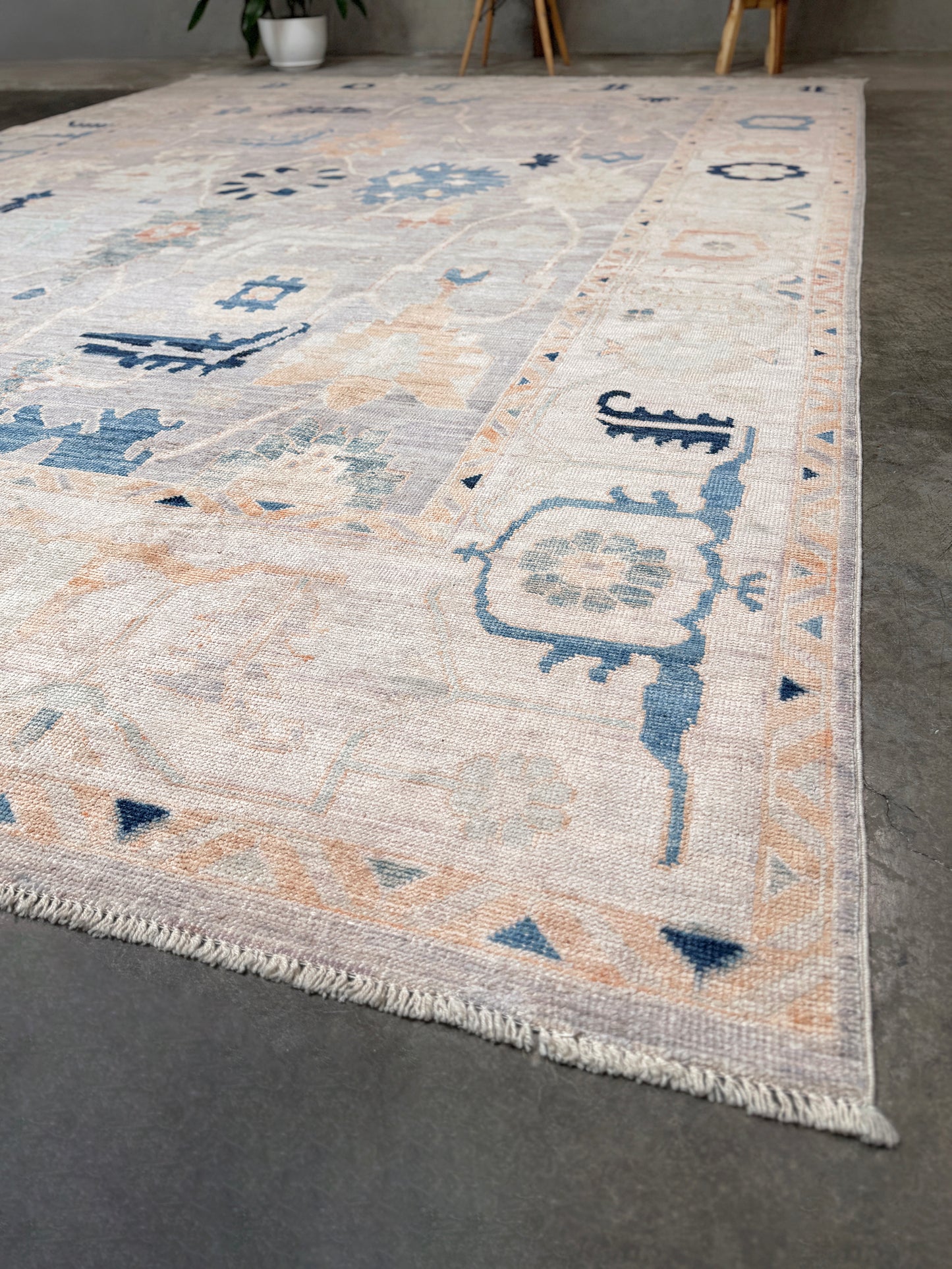 Brand new Turkish Oushak rug with pale blue field, subtle lilac undertones, soft ivory border, faded blue and peach beige accents, handmade wool area rug 9x12 from Indigo Rugs Burlingame Bay Area.