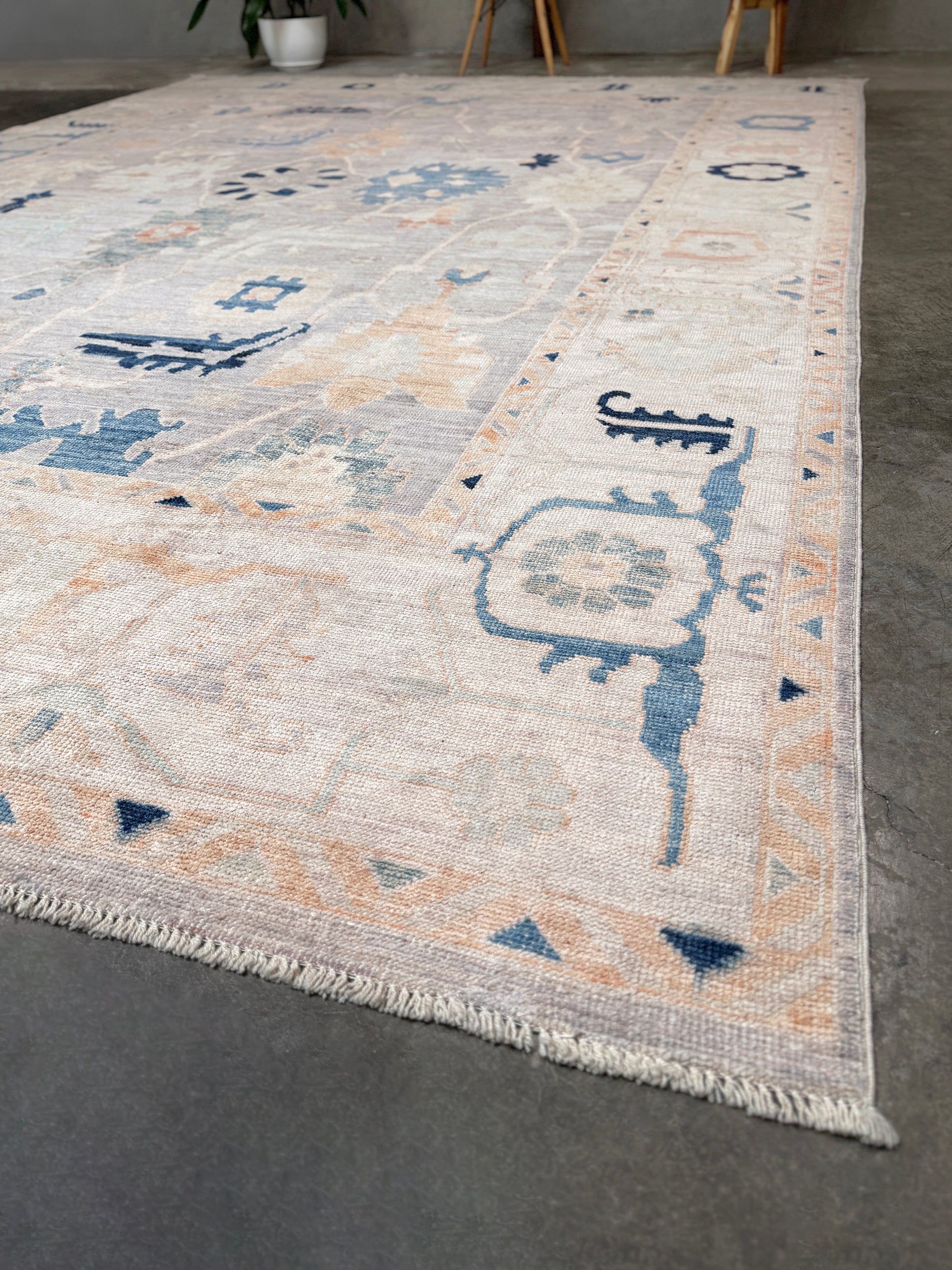 Brand new Turkish Oushak rug with pale blue field, subtle lilac undertones, soft ivory border, faded blue and peach beige accents, handmade wool area rug 9x12 from Indigo Rugs Burlingame Bay Area.
