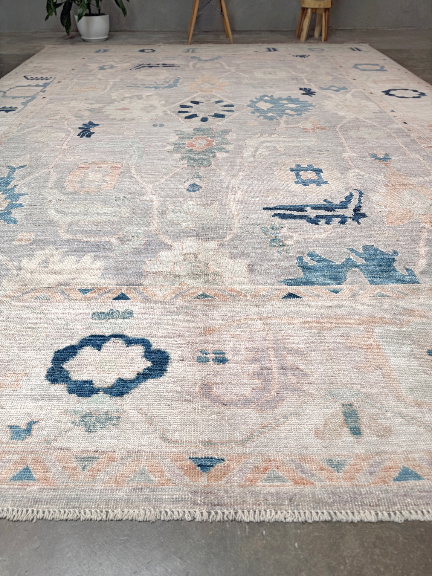 Brand new Turkish Oushak rug with pale blue field, subtle lilac undertones, soft ivory border, faded blue and peach beige accents, handmade wool area rug 9x12 from Indigo Rugs Burlingame Bay Area.