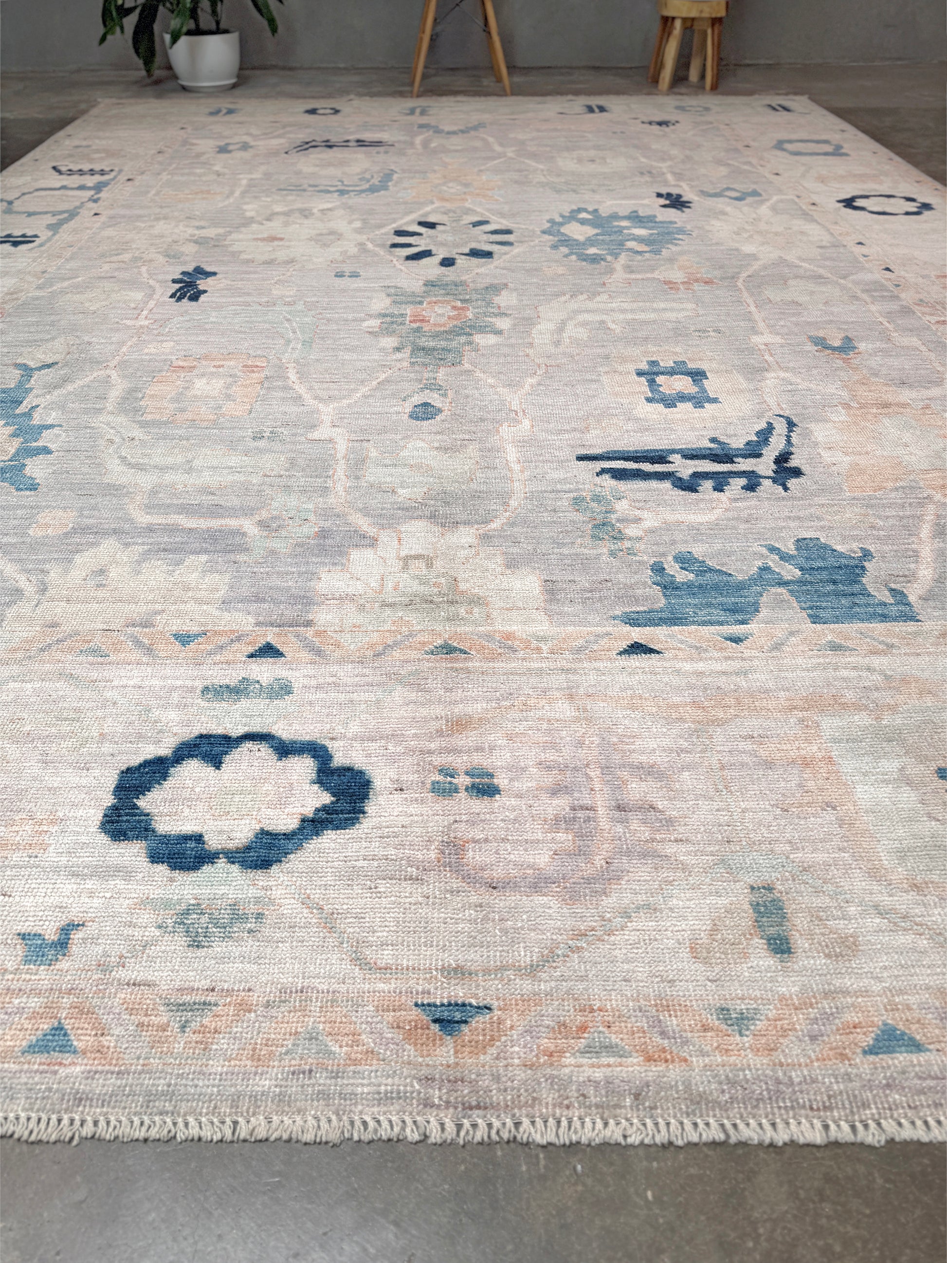 Brand new Turkish Oushak rug with pale blue field, subtle lilac undertones, soft ivory border, faded blue and peach beige accents, handmade wool area rug 9x12 from Indigo Rugs Burlingame Bay Area.