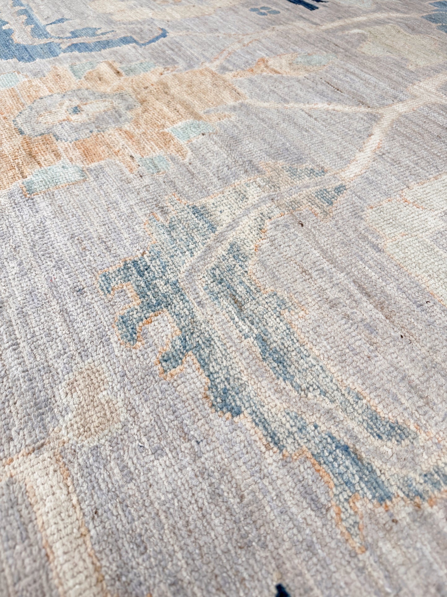 Brand new Turkish Oushak rug with pale blue field, subtle lilac undertones, soft ivory border, faded blue and peach beige accents, handmade wool area rug 9x12 from Indigo Rugs Burlingame Bay Area.